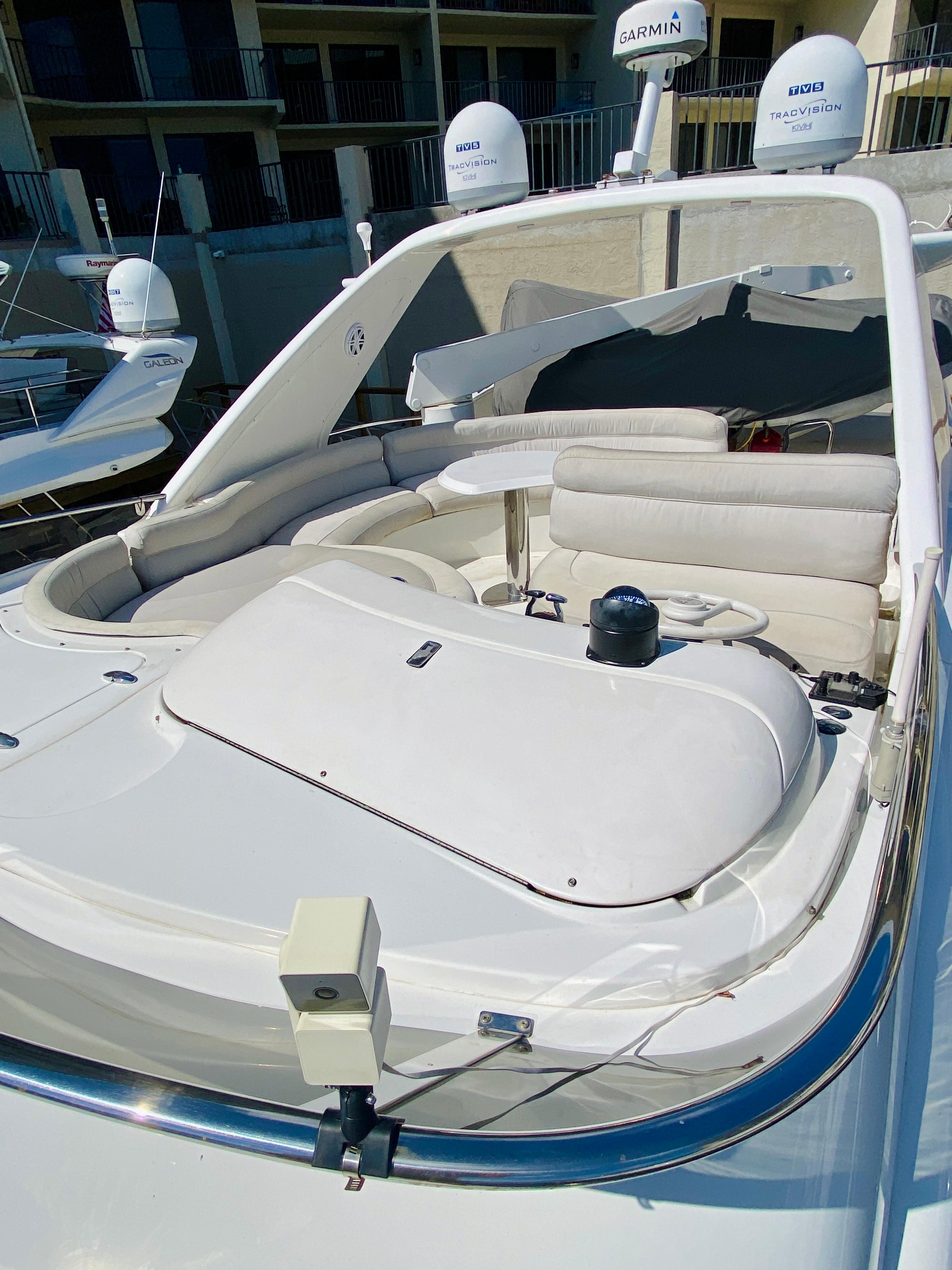 Azimut 55 yacht, 2002 model, featuring a sleek white deck and modern design elements.