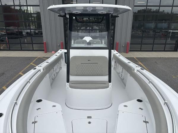 2025 Sportsman Open 232 boat interior with seating and console, parked outdoors.