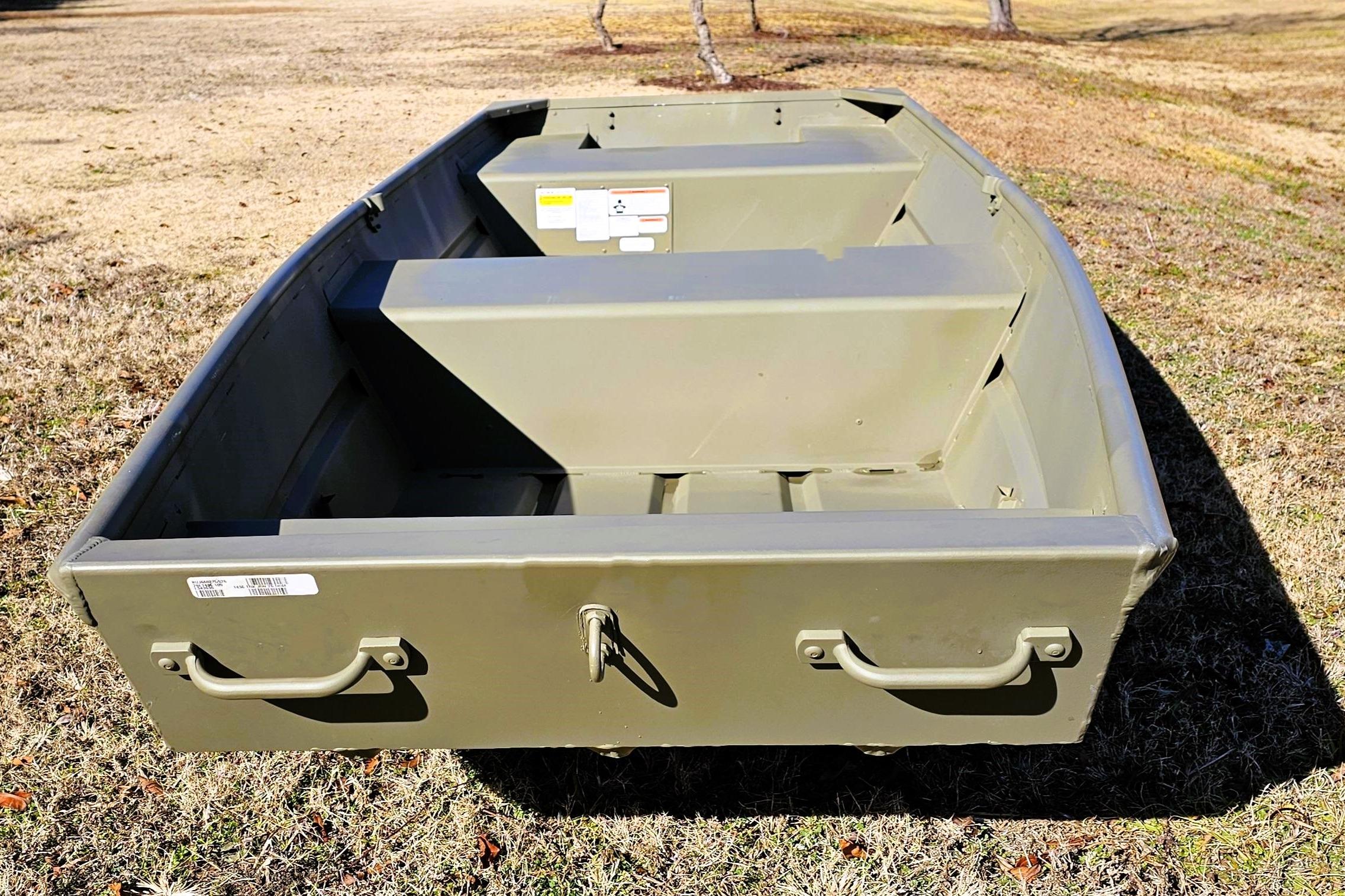 2026 Tracker Grizzly 14 Jon boat on grass, showcasing its sturdy, open design.