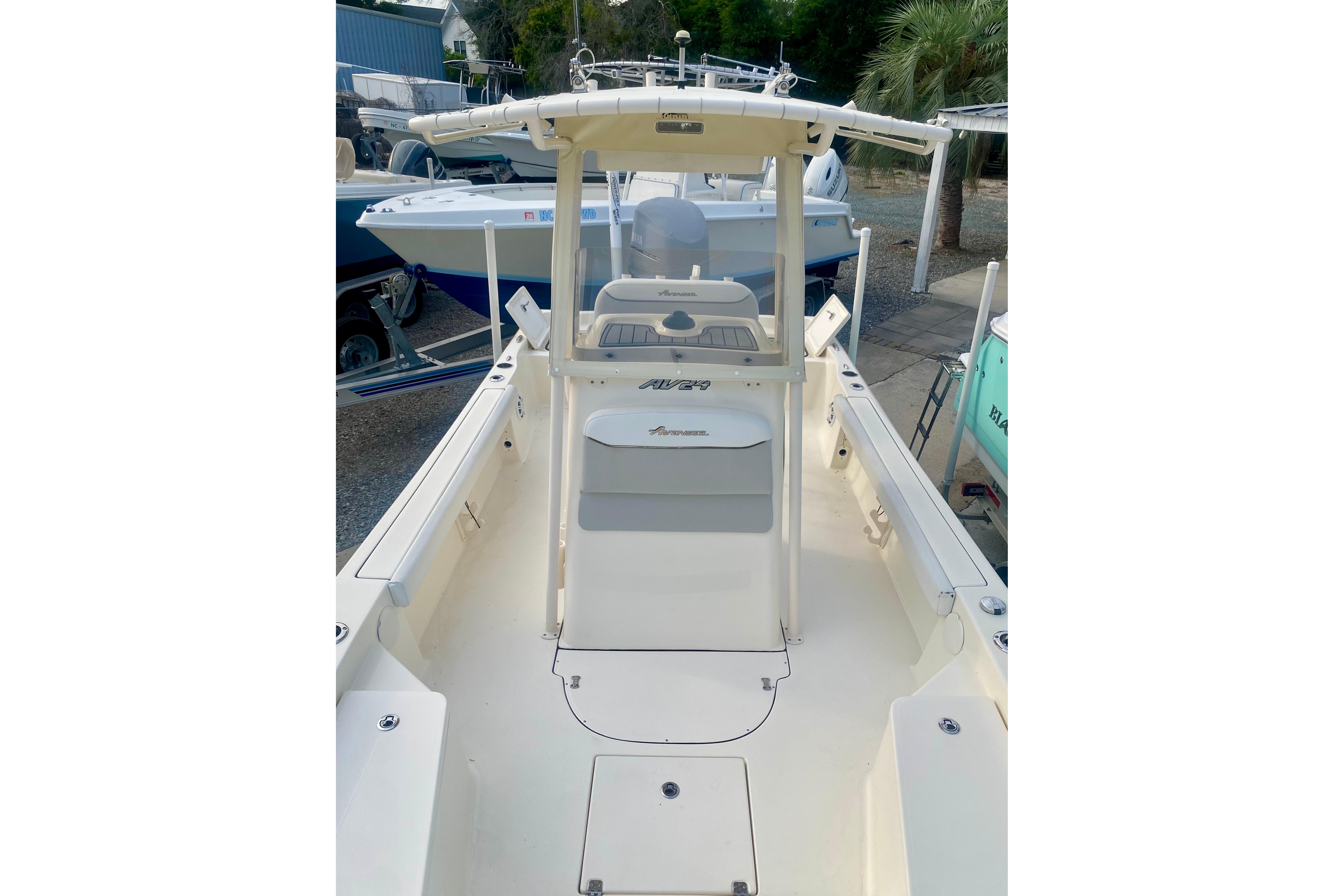 2018 Avenger AV24 boat with center console, docked outdoors.