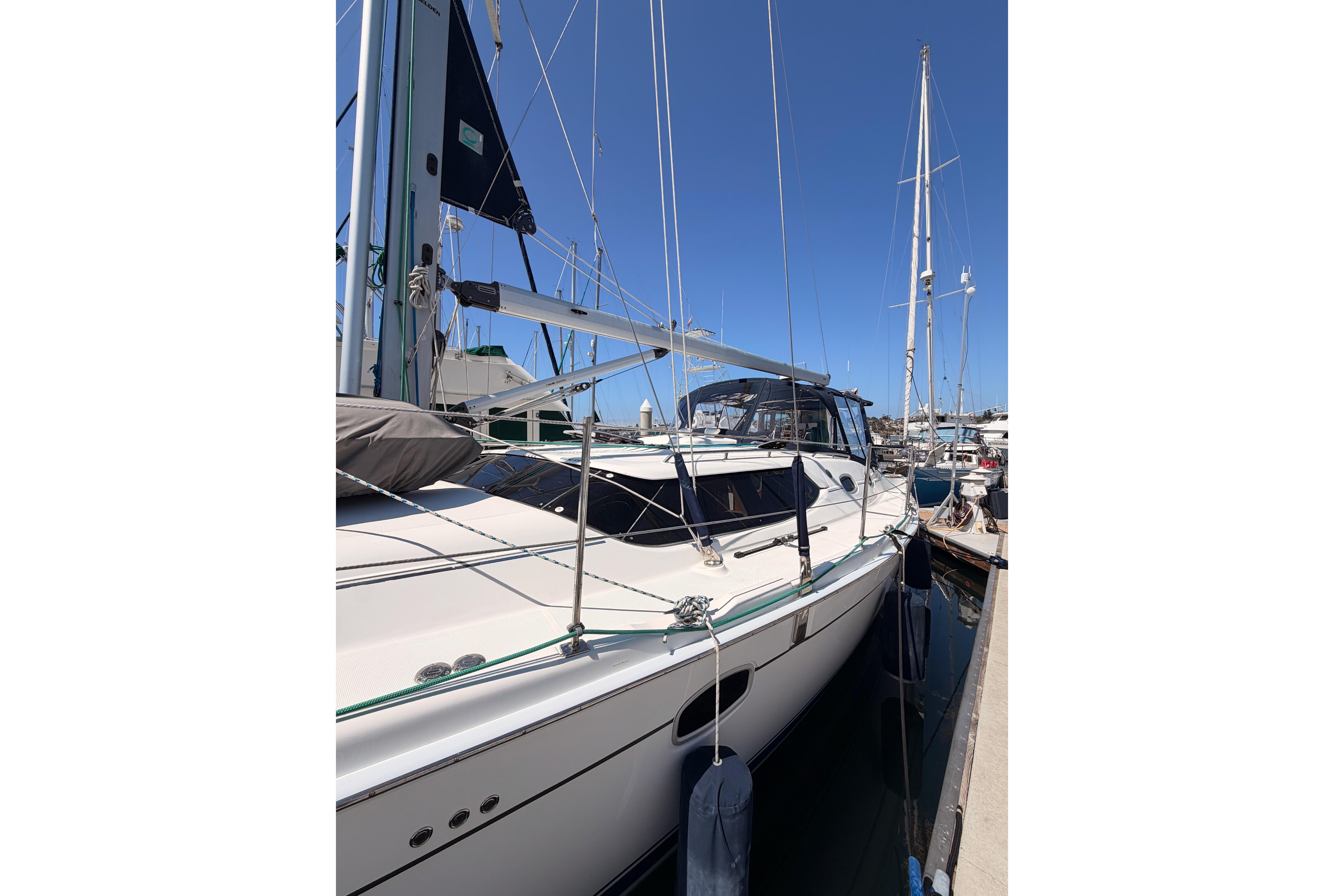 2008 Hunter 45 Deck Salon sailboat docked at marina under clear blue sky.
