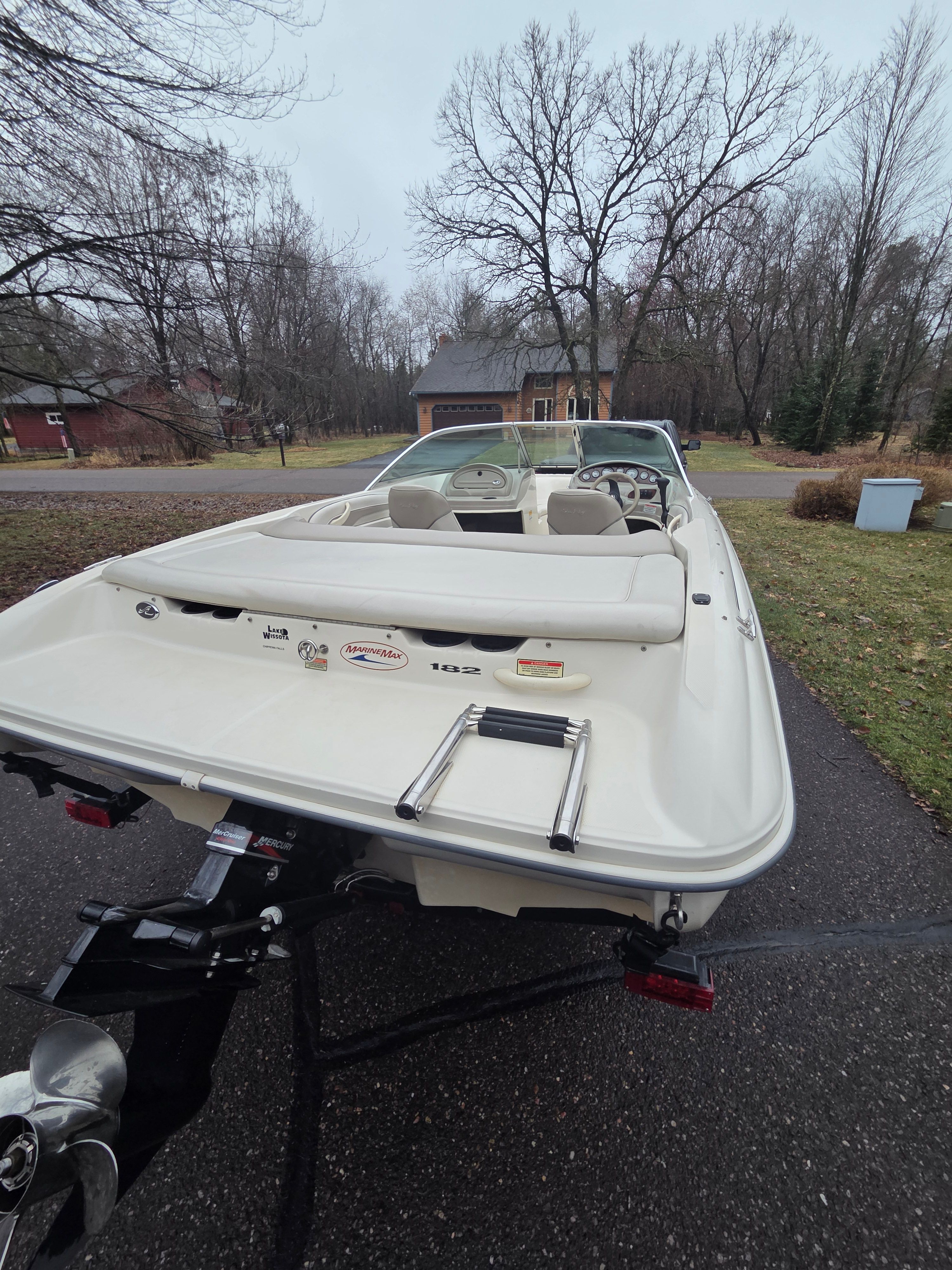 2002 Sea Ray 182 boat parked on a trailer outdoors.