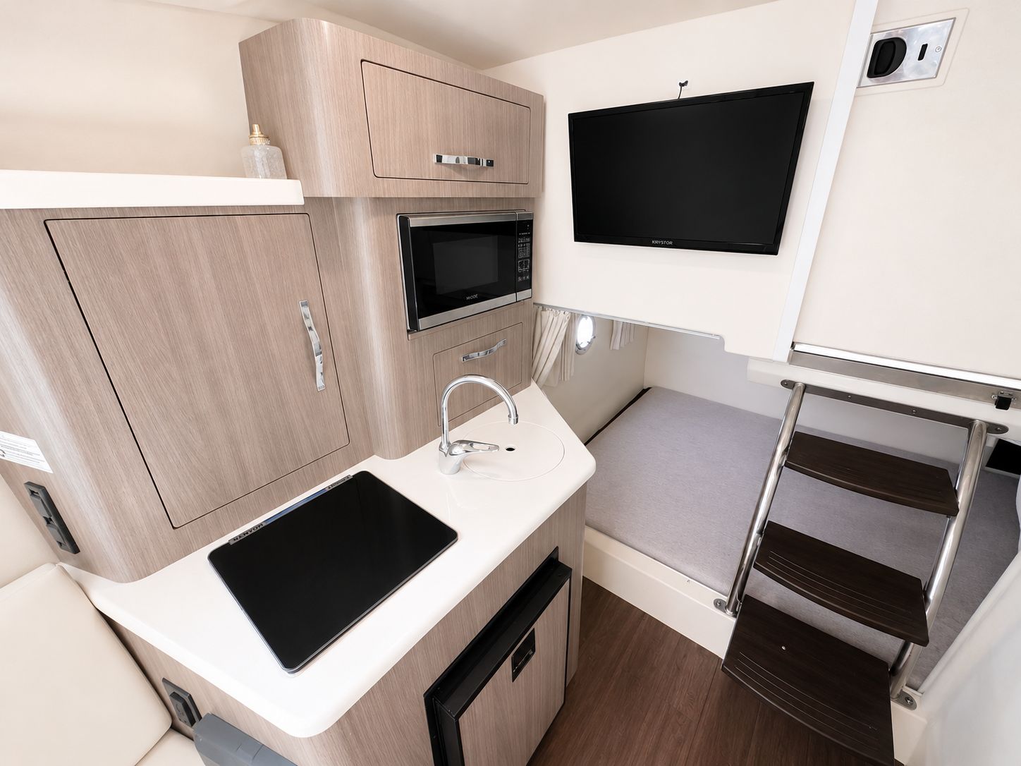 Interior of the 2020 Regal 28 Express with kitchenette and sleeping area.