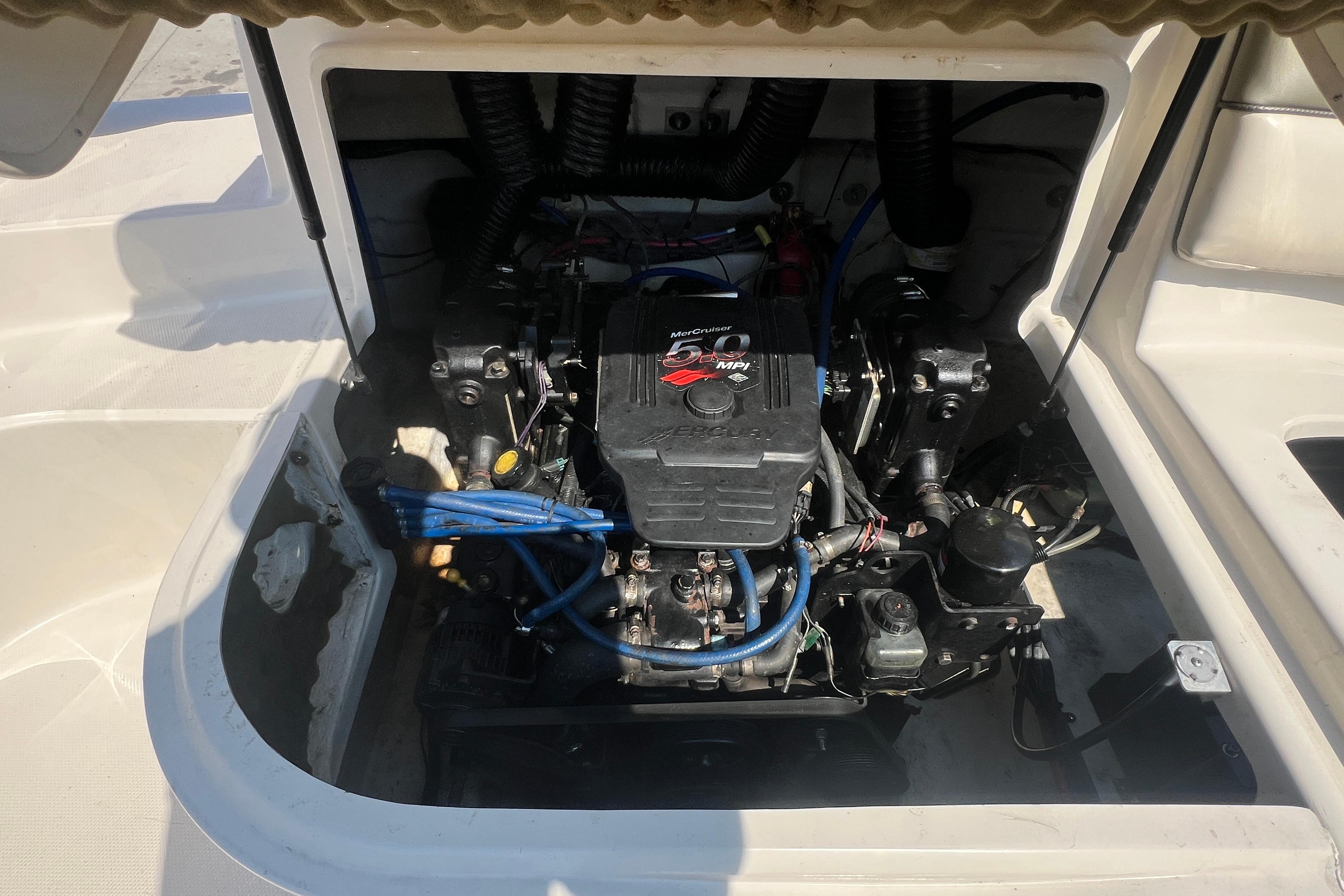 Engine compartment of a 2005 Sea Ray 240 Sundeck boat, featuring a MerCruiser engine.