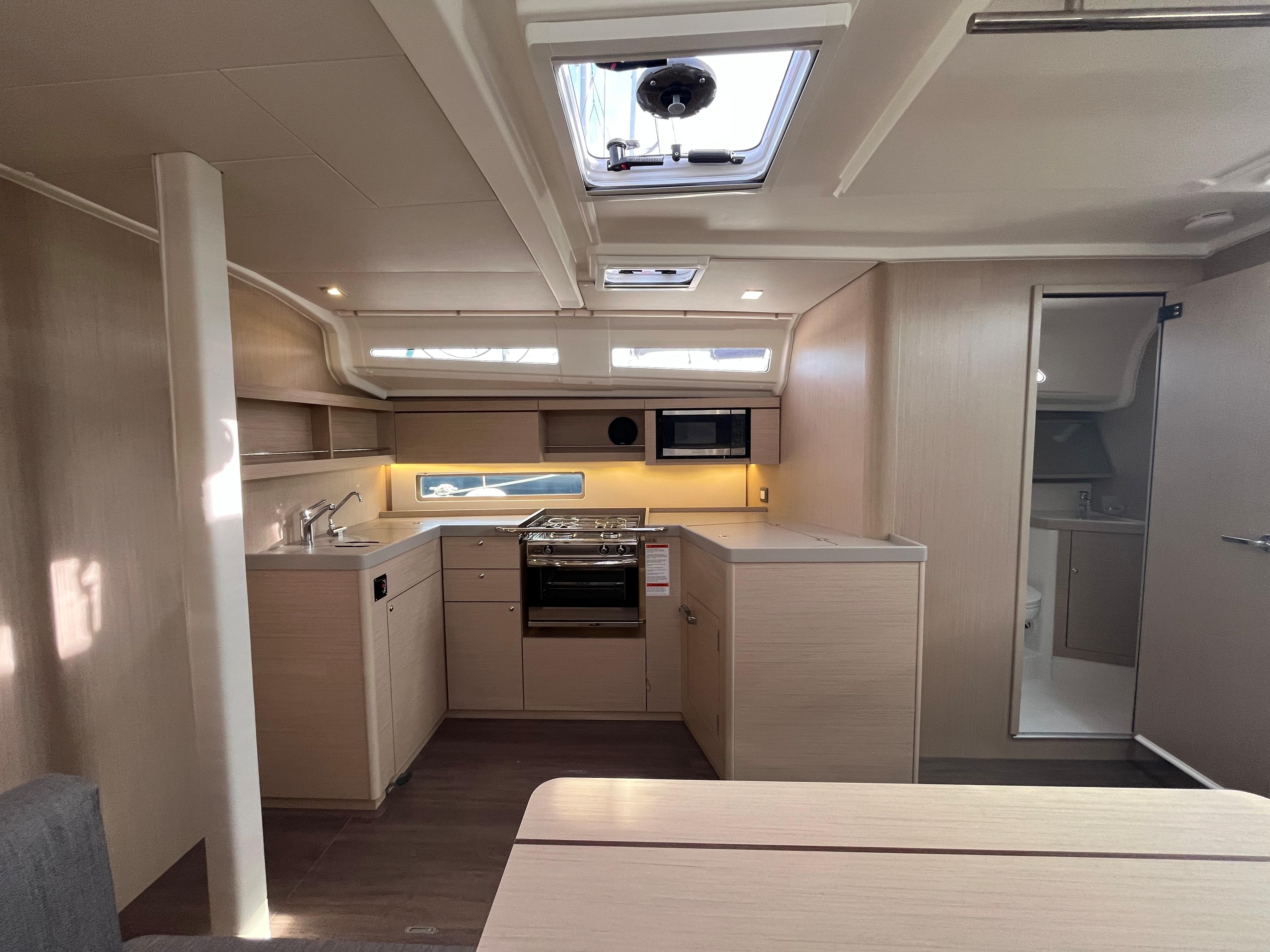 2023 Beneteau Oceanis 40.1 yacht interior with modern kitchen and skylight.