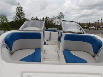 2004 Mariah SK-10 boat interior with blue and white seating, under cloudy sky.