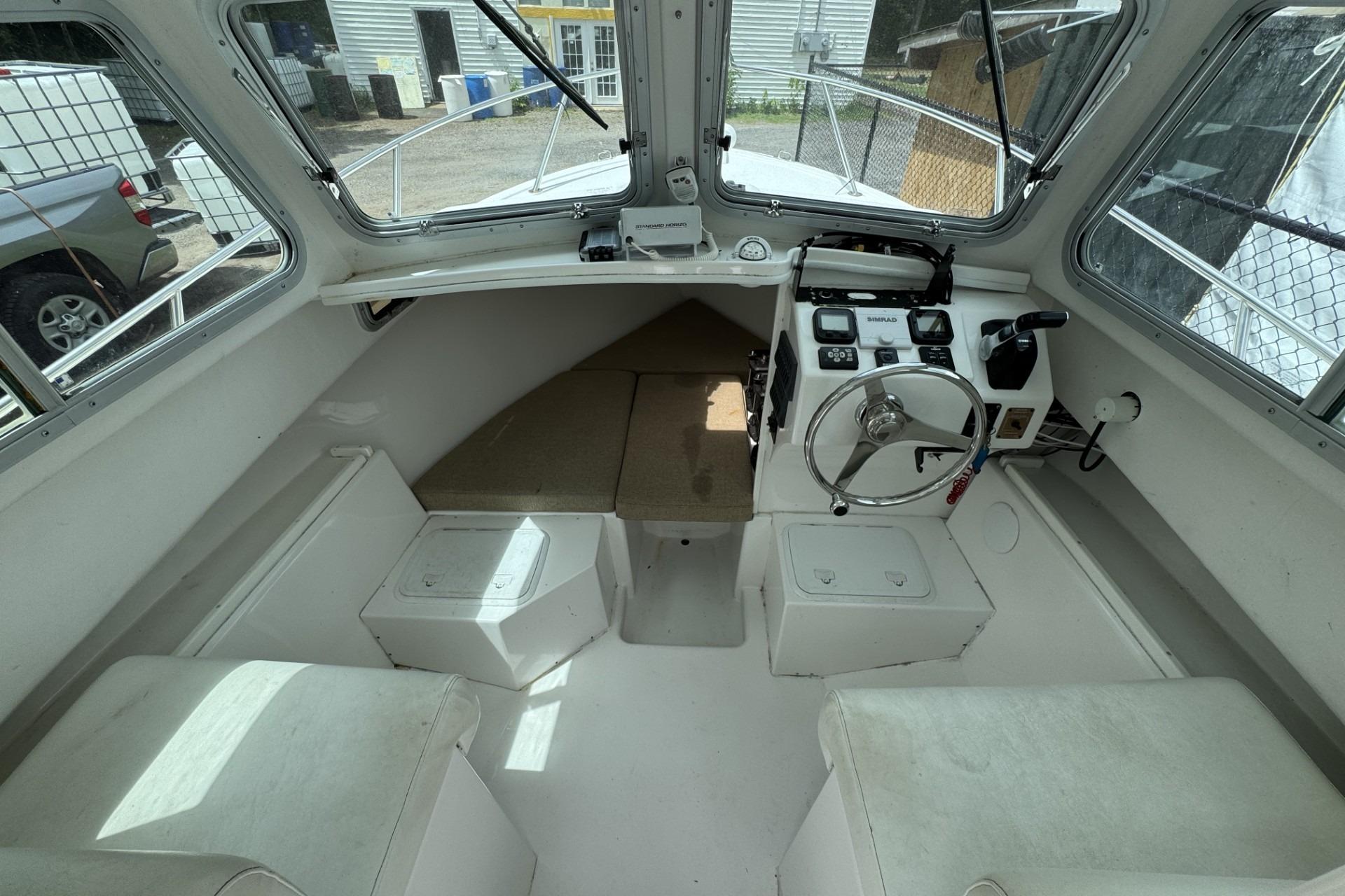 2016 Steiger Craft 25 Chesapeake boat interior with steering wheel and seating.