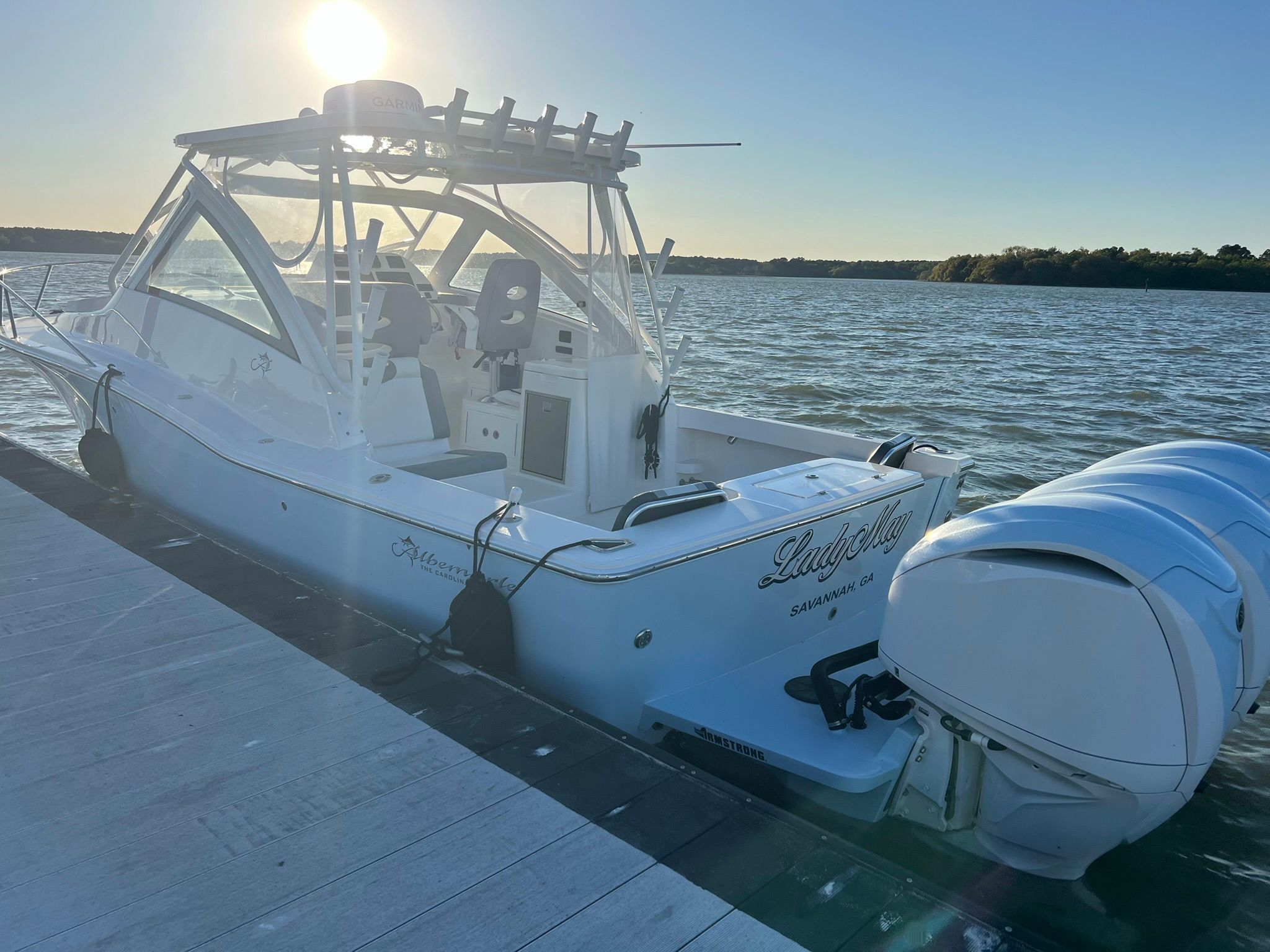 2024 Albemarle 30 Express docked, featuring dual outboard engines and a sunset backdrop.