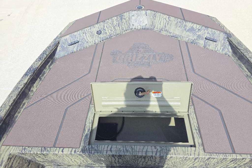 2026 Tracker Grizzly 1860 CC boat deck with open storage compartment.