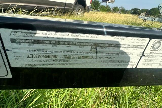 Label on a 2019 Sun Tracker Party Barge 22 XP3 trailer in grassy area.