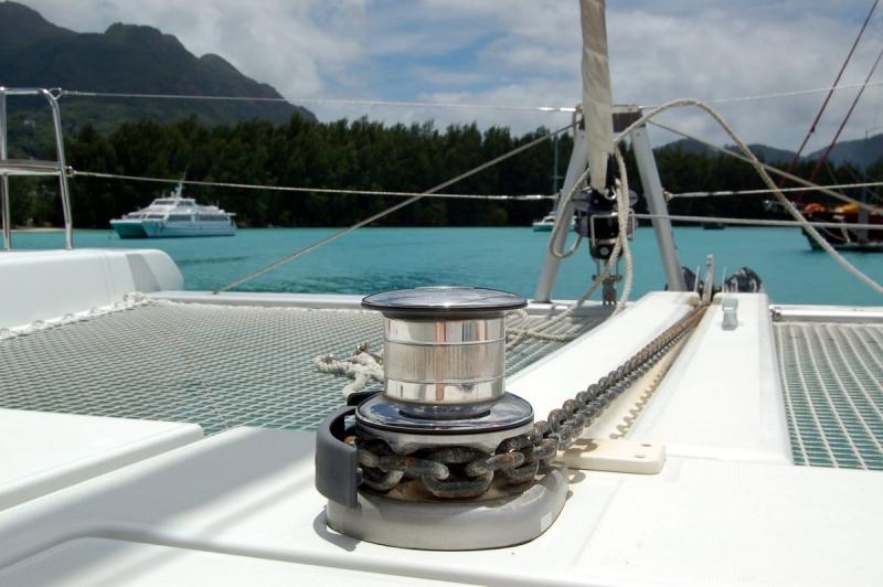 2018 Lagoon 40 catamaran deck with winch, turquoise water, and distant boats.