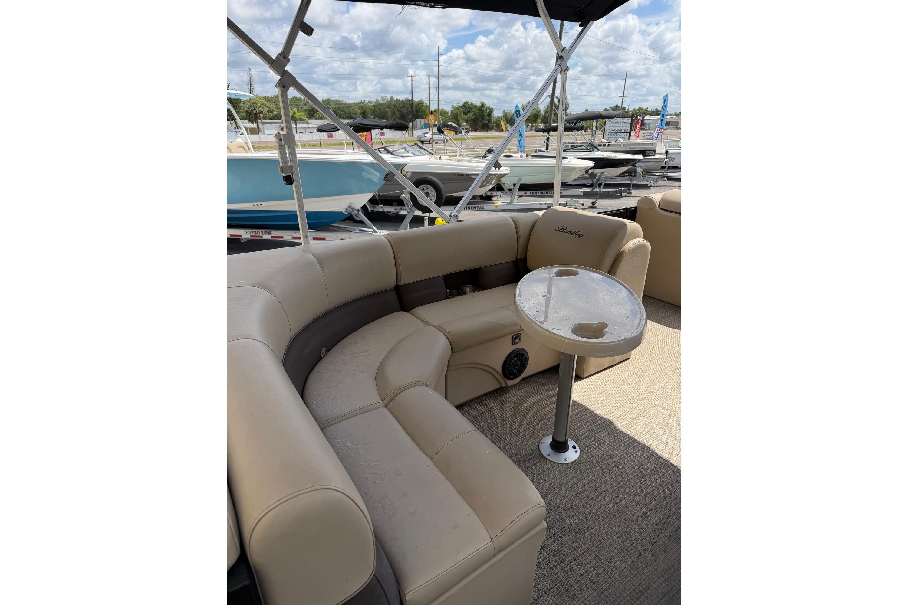 2022 Bentley Pontoons 240 CRUISE interior with beige seating and small table.