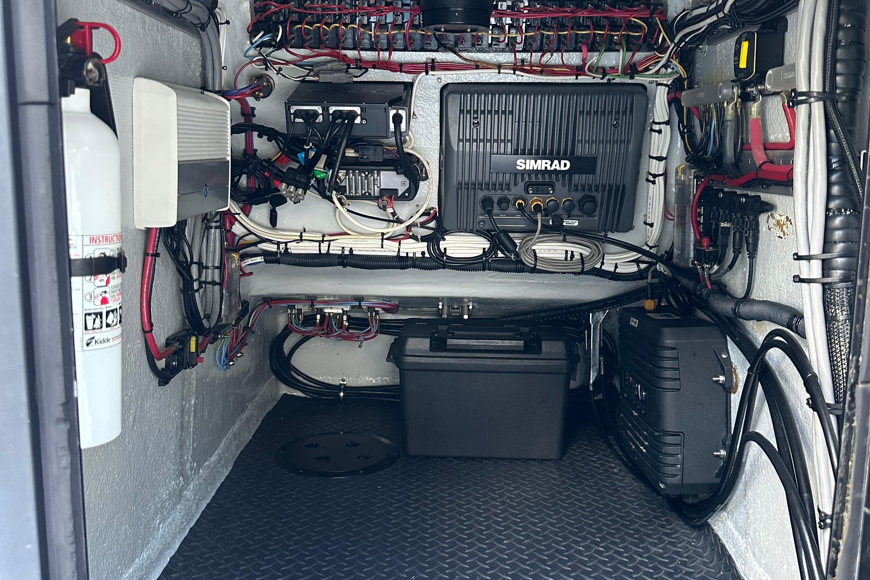 2004 SeaVee Center Console boat electronics compartment with Simrad equipment and wiring.