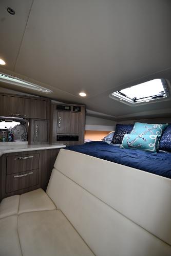 2021 Regal 35 Sport Coupe interior cabin with bed, skylight, and modern cabinetry.