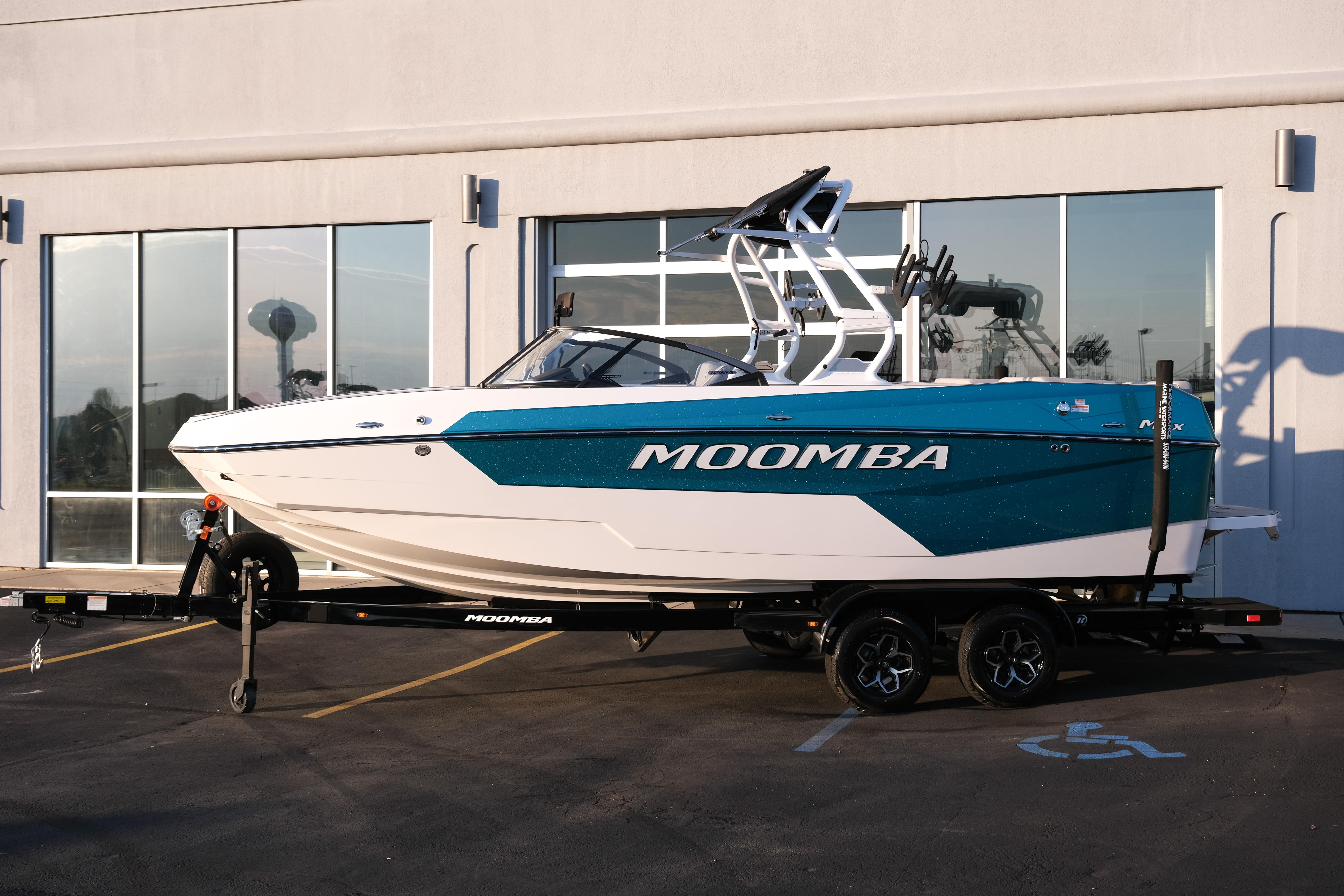 2026 Moomba Max boat on trailer, parked outside a building.
