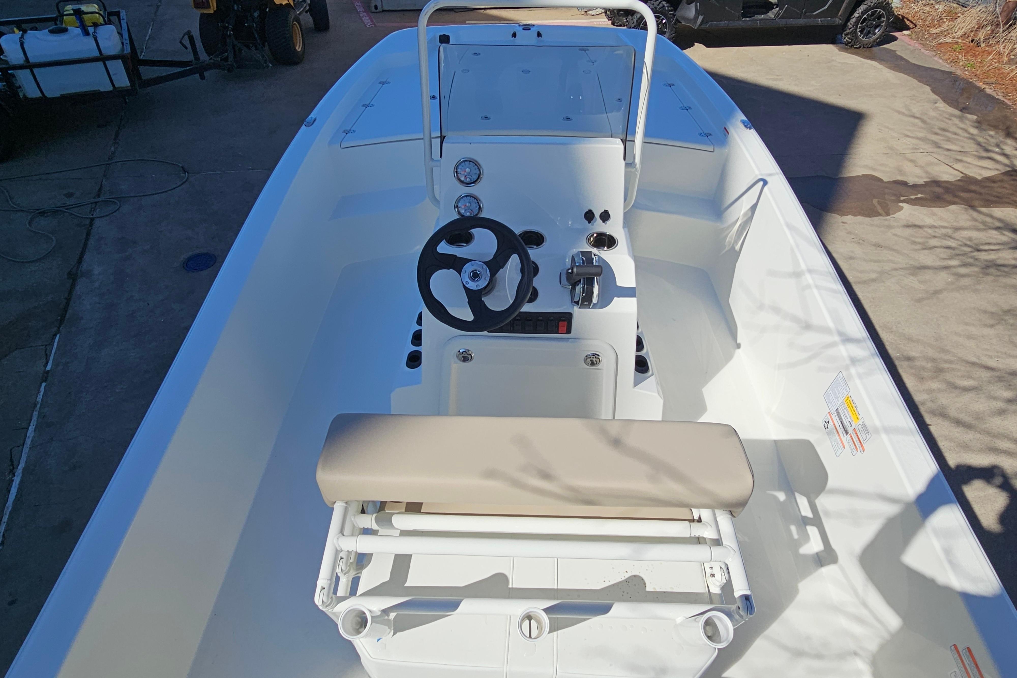 2026 Mako Pro Skiff 19 CC boat interior with steering console and seating.