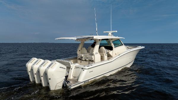 2025 Scout 425 LXF boat cruising on open water with multiple outboard engines.