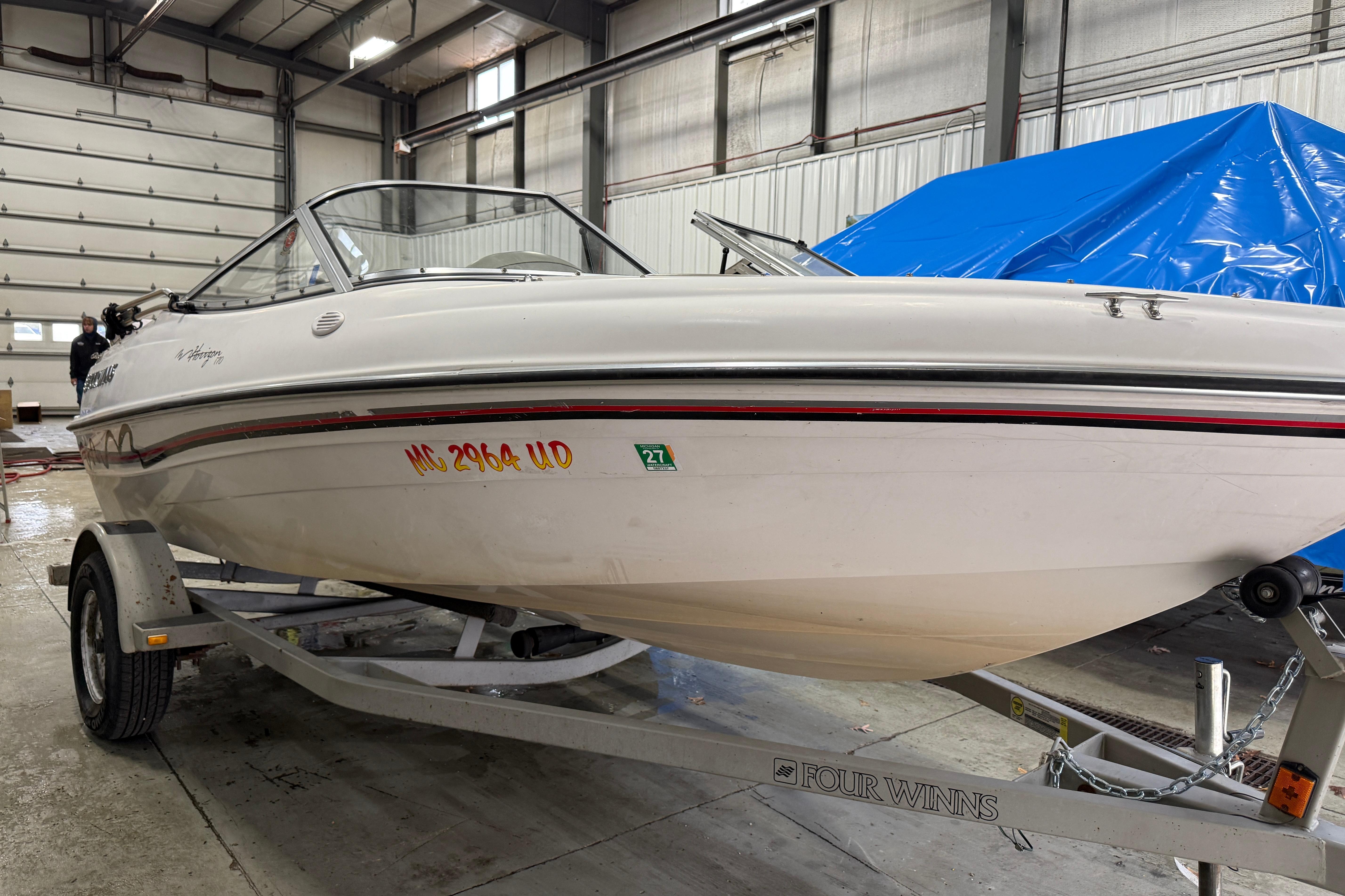 1999 Four Winns 170 Horizon LE boat on trailer in indoor storage facility.