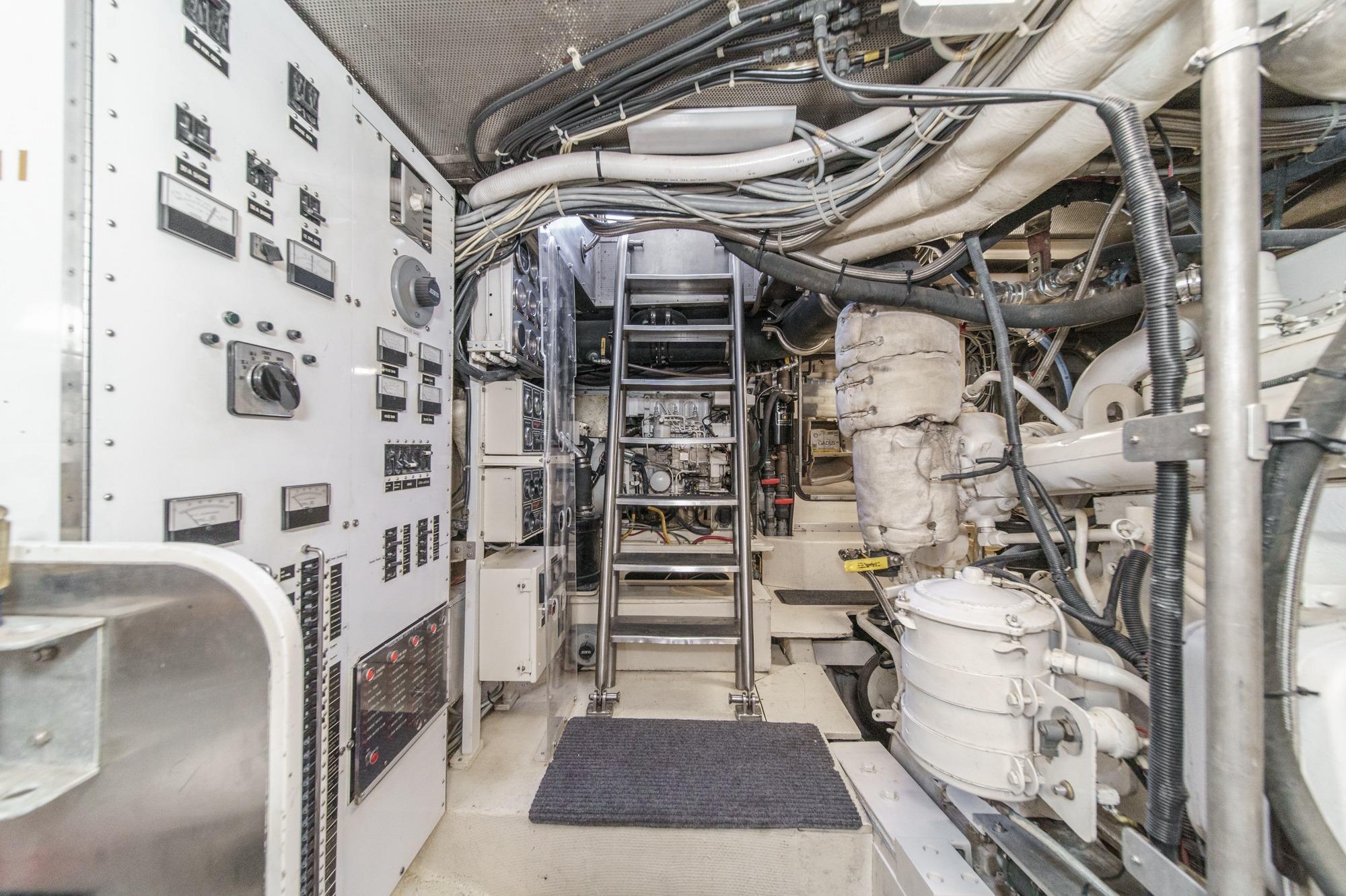 Engine room of a 1990 Seaton Long Range Cruiser, featuring control panels and machinery.