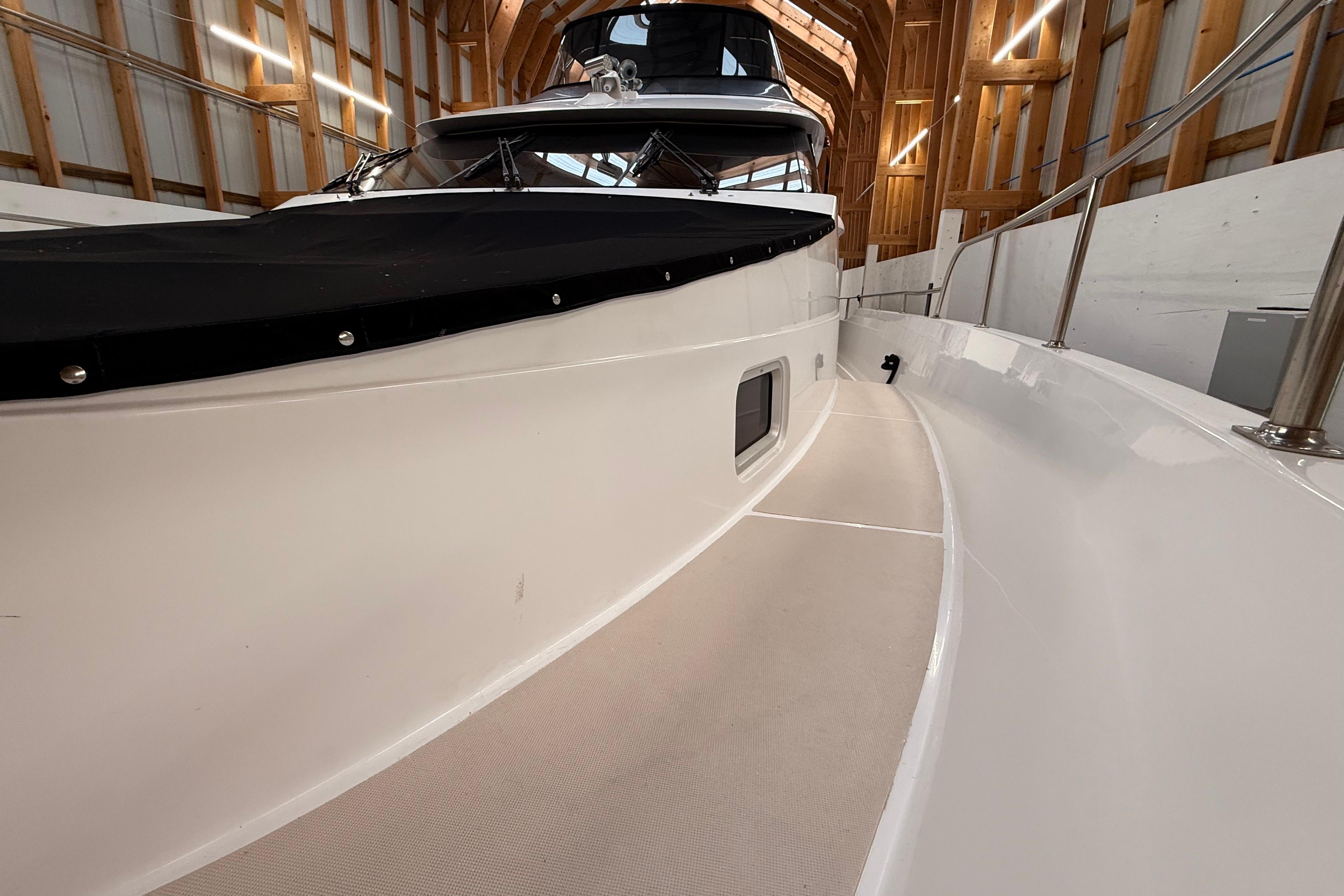 Northern Pacific 2000 Motor Yacht in wooden boathouse, showcasing sleek deck design.