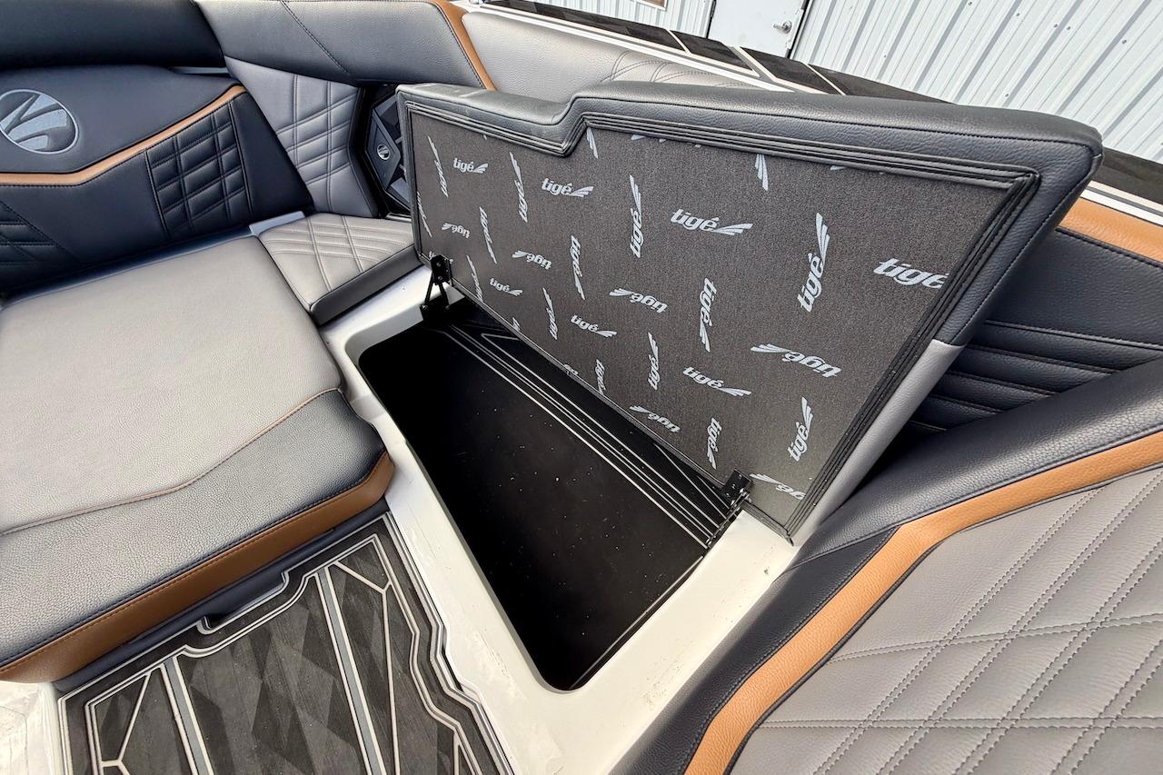 2025 Tigé Ultré 25ZX boat interior with open storage compartment and stylish seating.