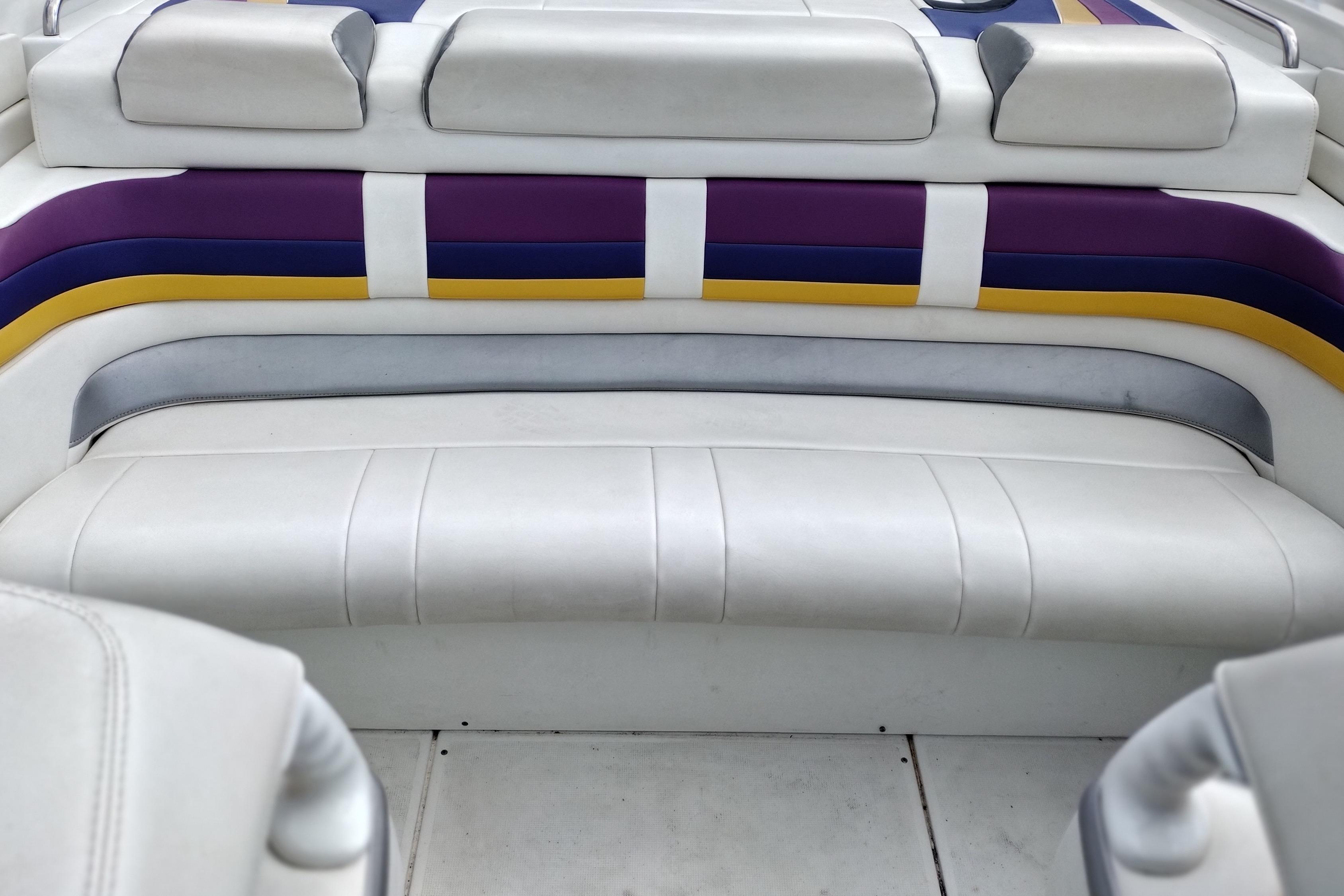 2006 Formula 353 FASTech boat interior with white, purple, and yellow seating.