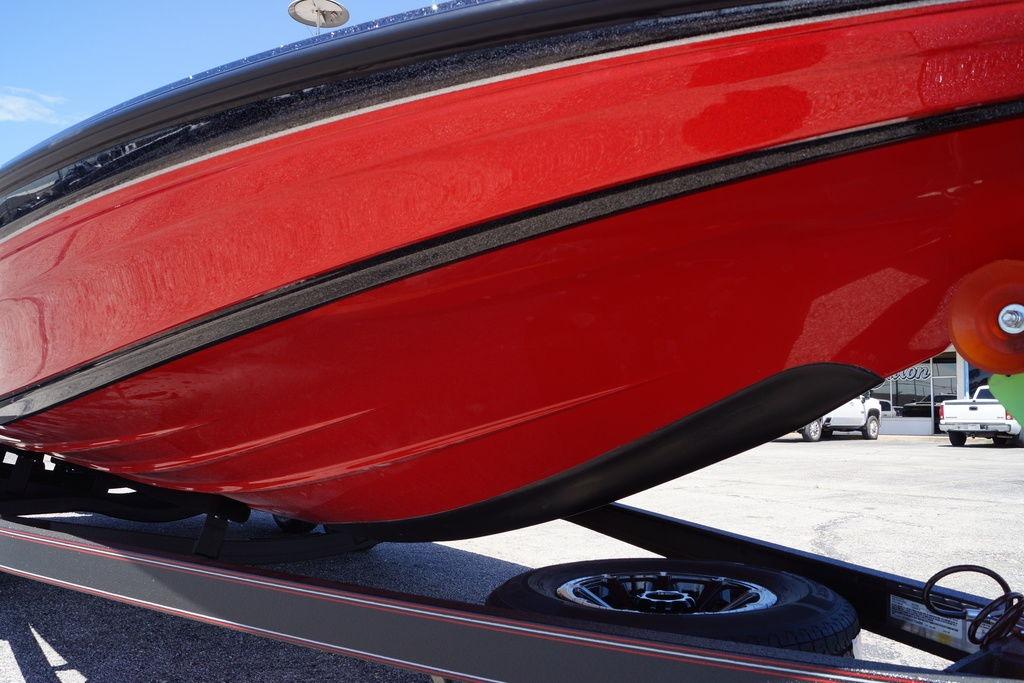 Red 2026 Skeeter ZXE21 boat hull on trailer, showcasing sleek design.