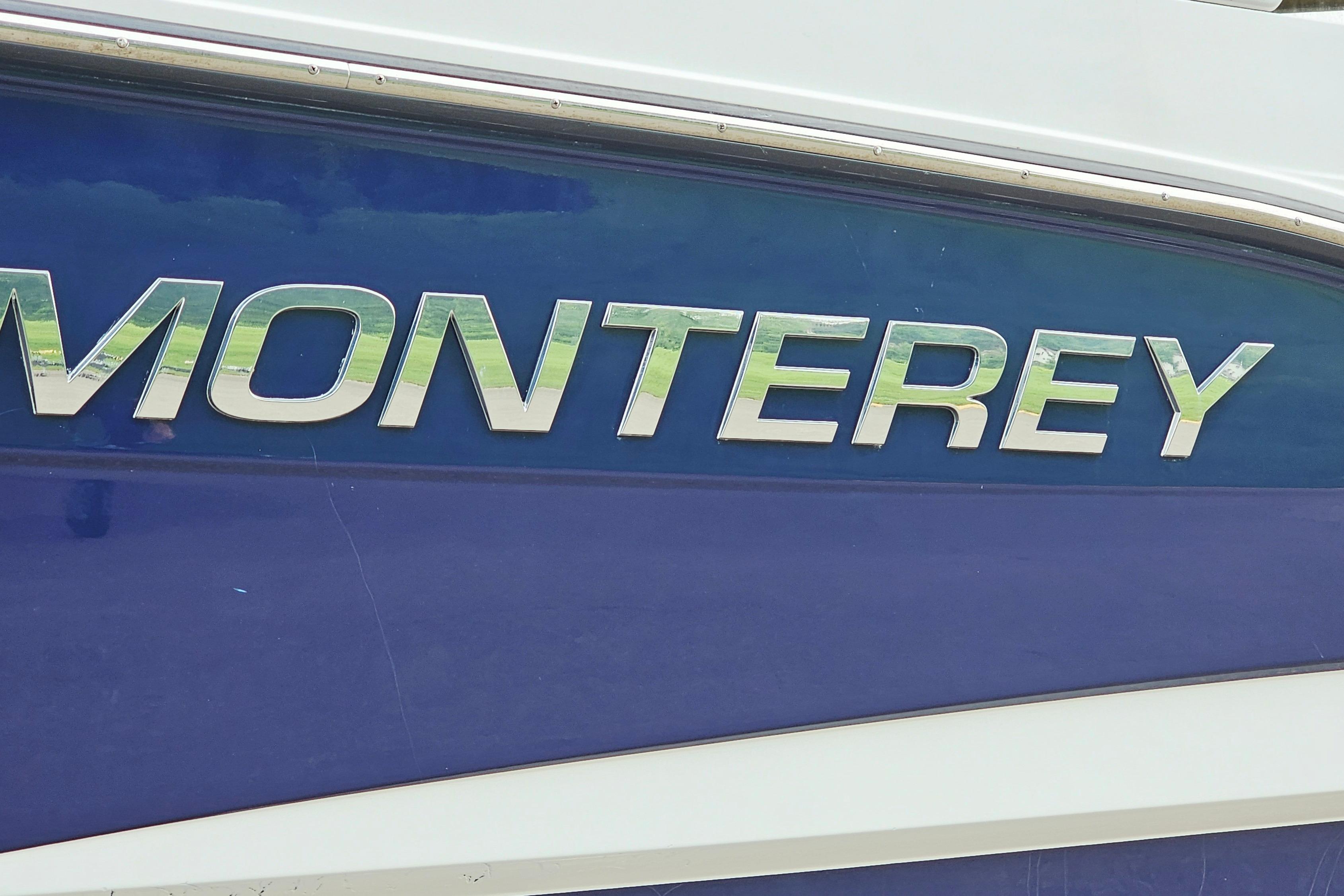 Monterey 295 Sport Yacht 2016 model nameplate on blue hull.