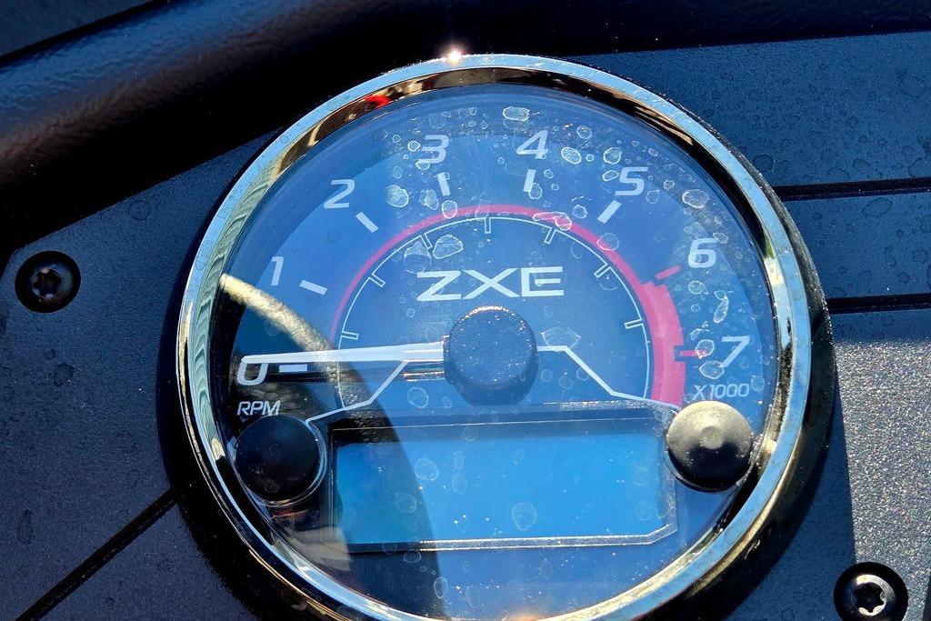 Close-up of 2026 Skeeter ZXE20 tachometer displaying RPM gauge with water droplets.