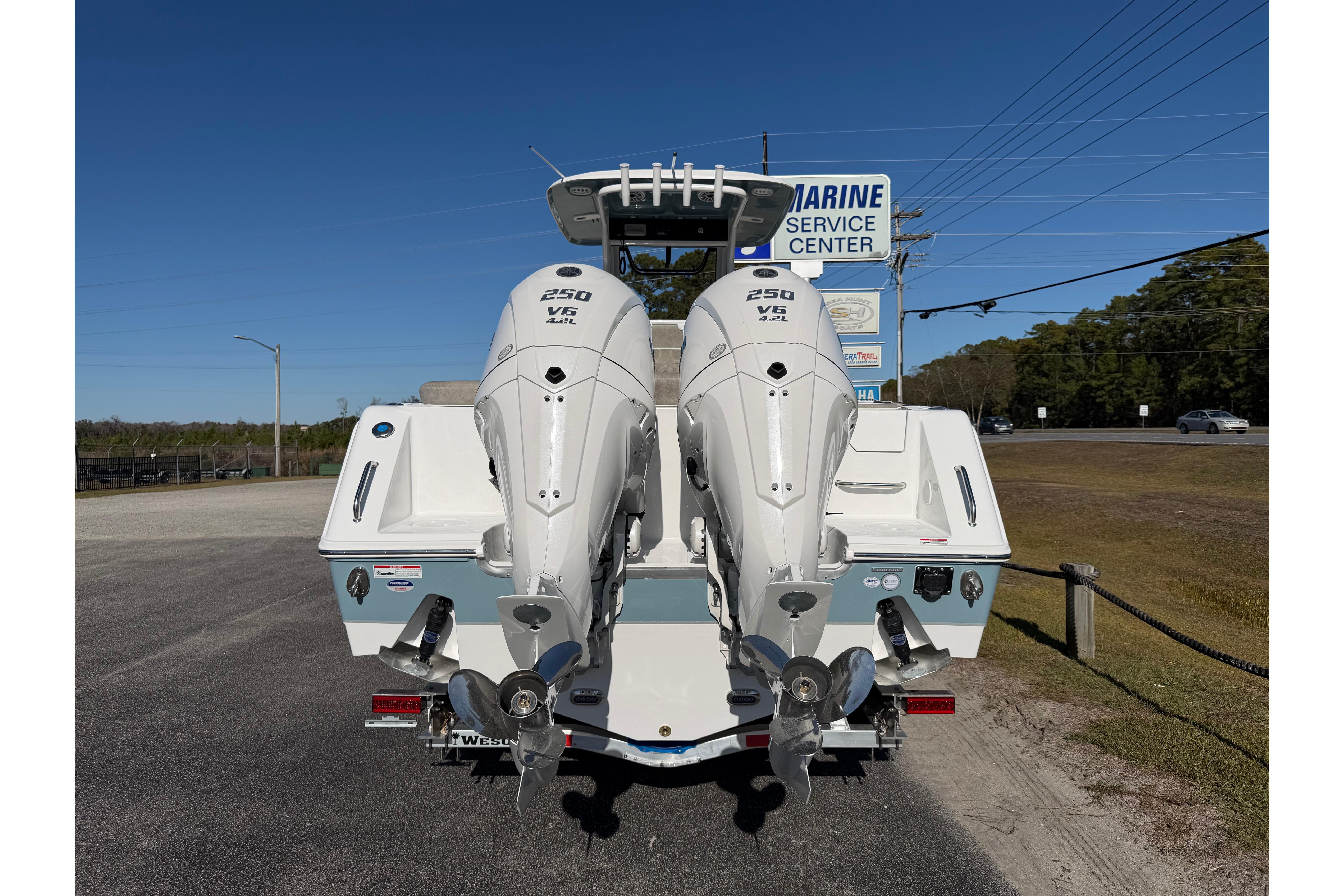 2026 Sea Hunt Ultra 275 Coffin Box with twin 250 V6 engines at marine service center.
