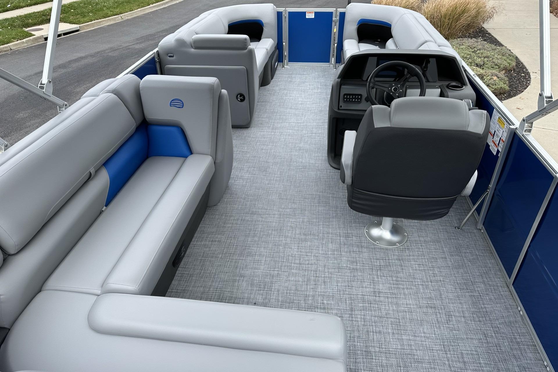 2026 Sun Tracker Party Barge 20 DLX interior with gray seating and steering console.