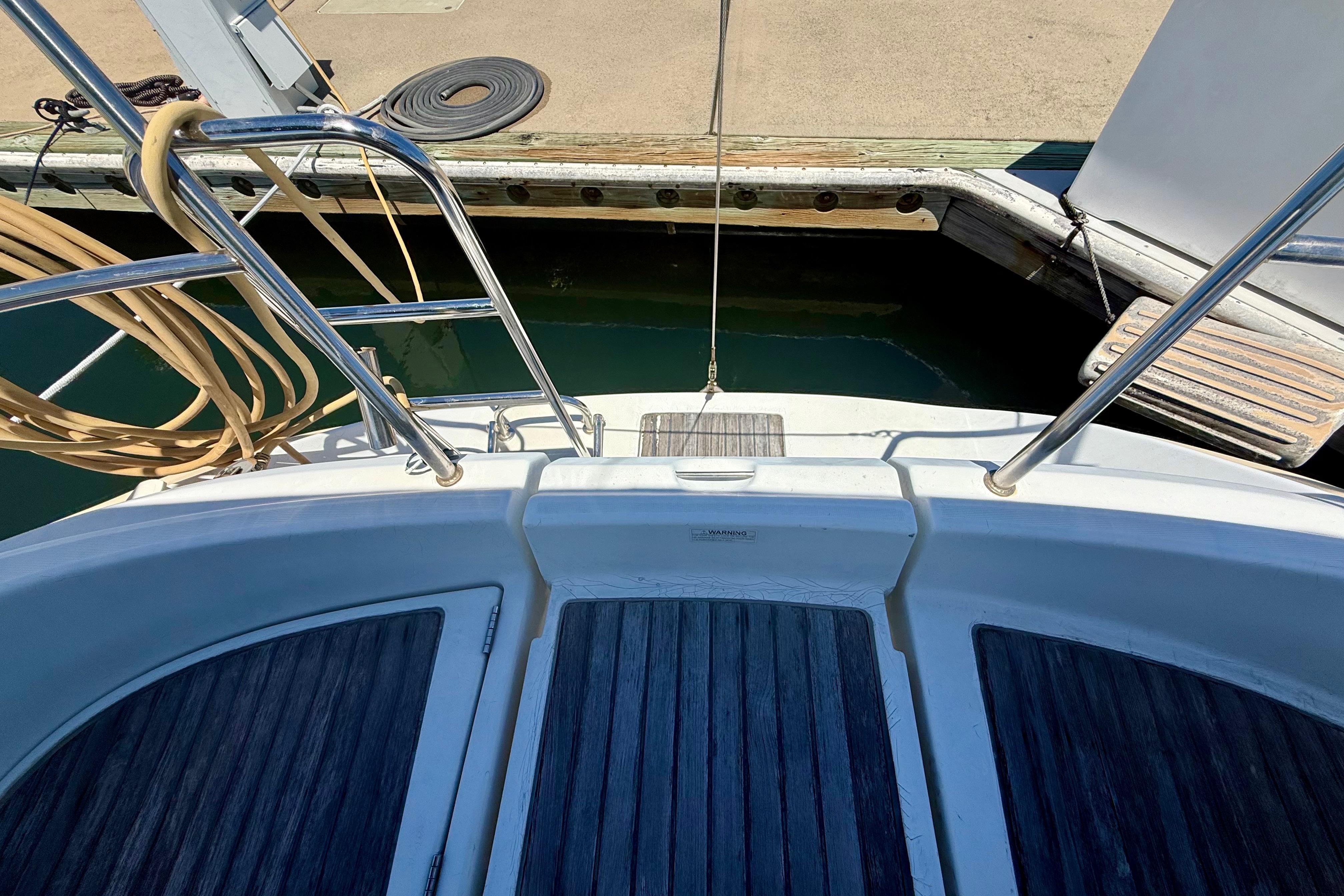 Beneteau Oceanis Clipper 311, 2002 model, docked with visible deck and railing.