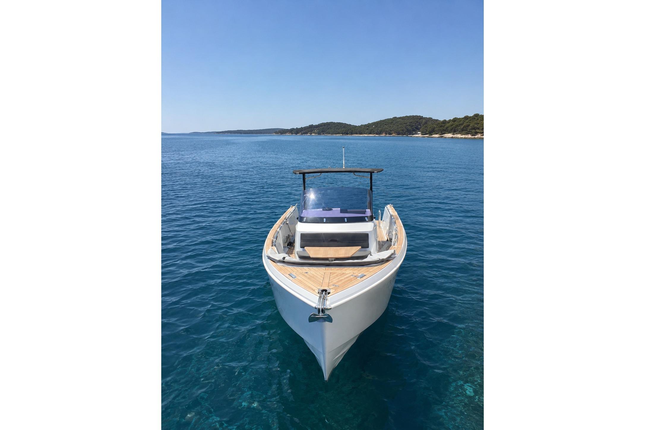 2015 Fjord 36 Open boat on clear blue water, sunny day.