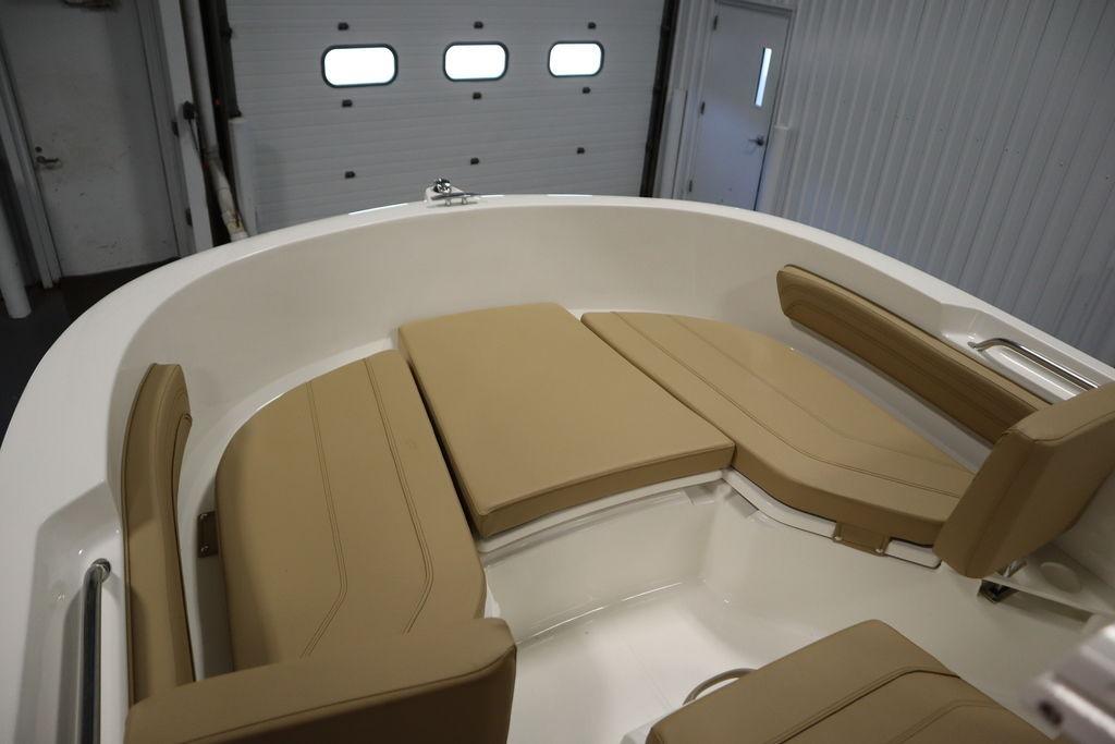 2026 Bayliner Trophy T20CC boat interior with beige cushioned seating.