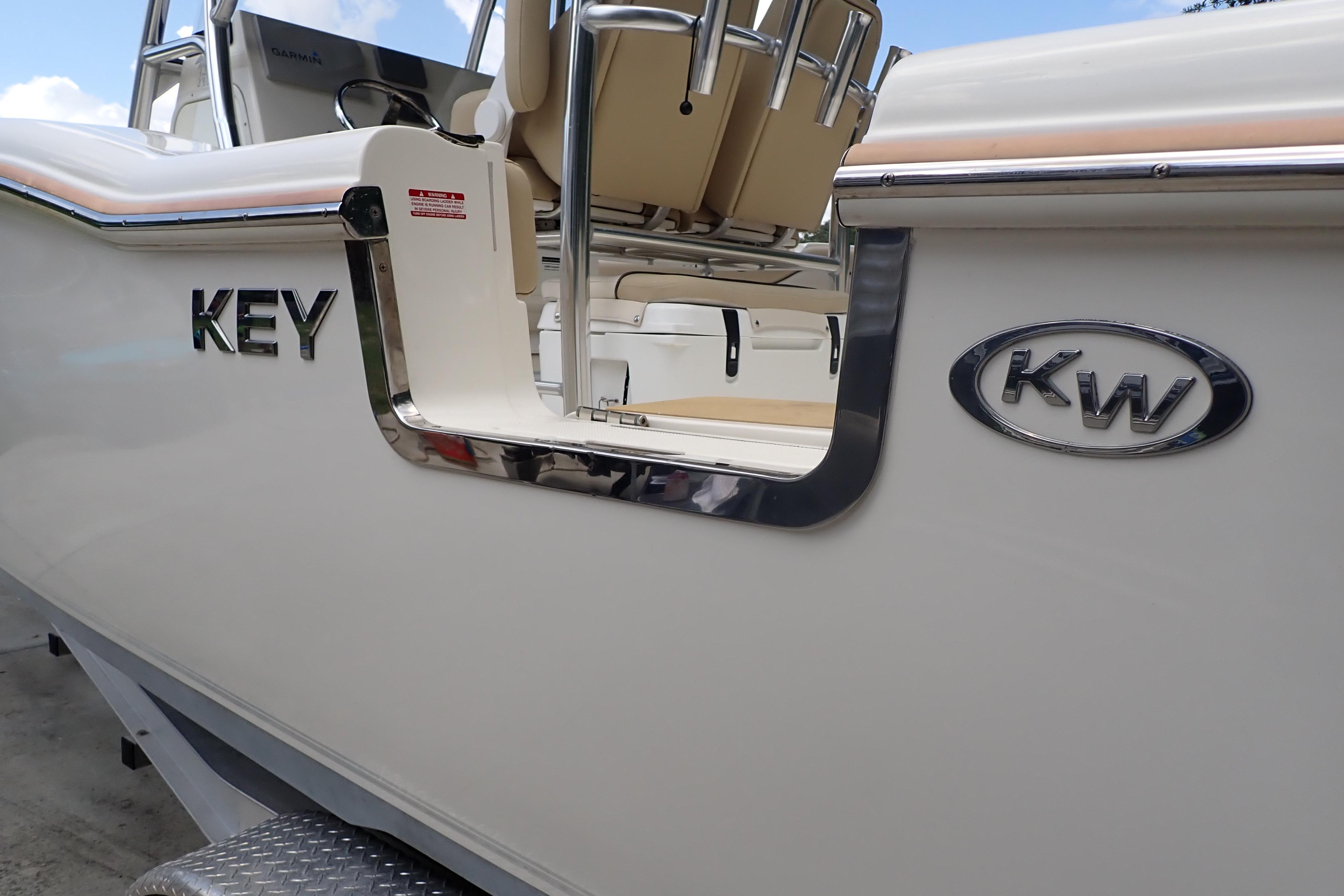 2019 Key West 263 FS boat side view with logo and seating.