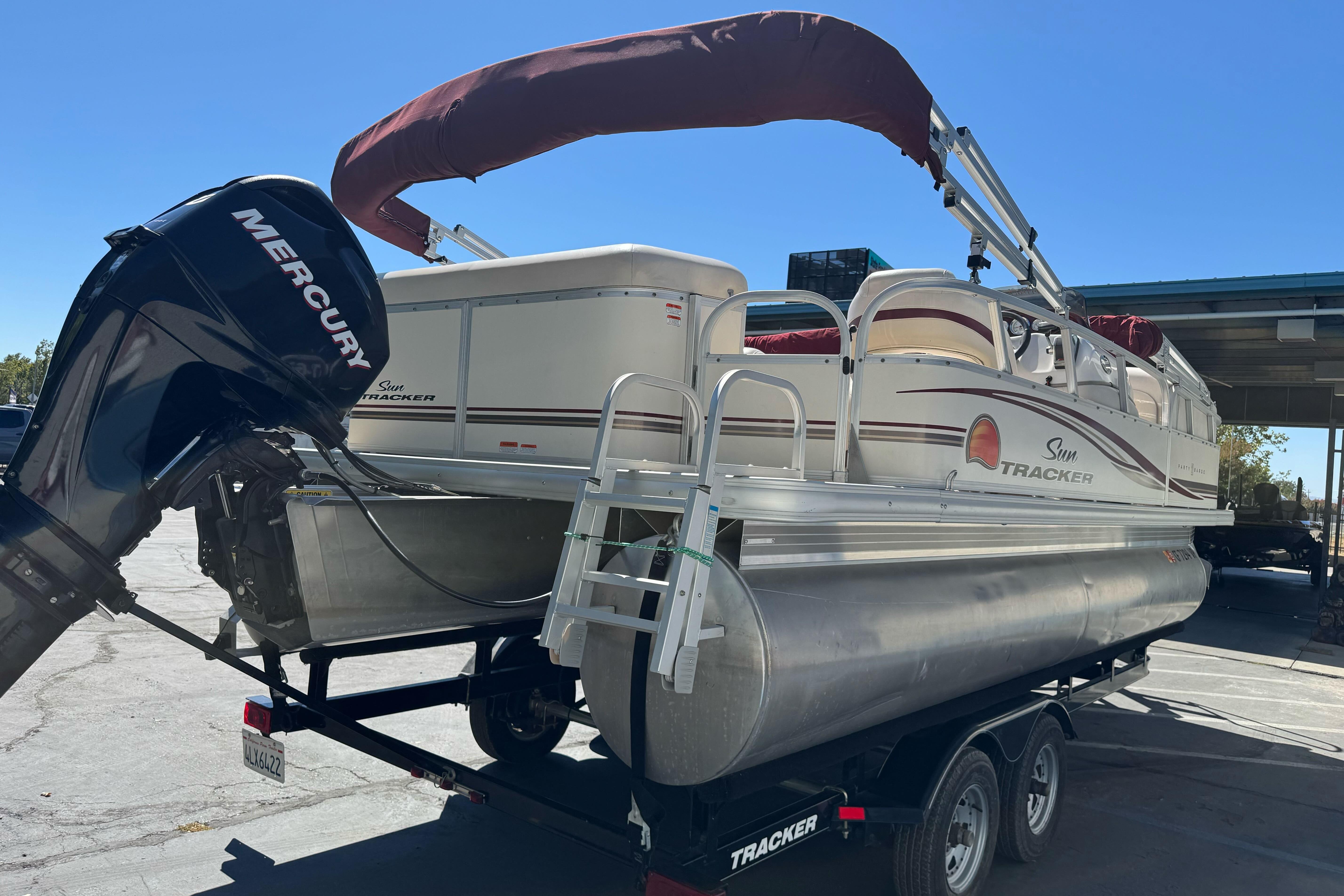 2011 Sun Tracker Party Barge 21 pontoon boat with Mercury outboard motor on trailer.