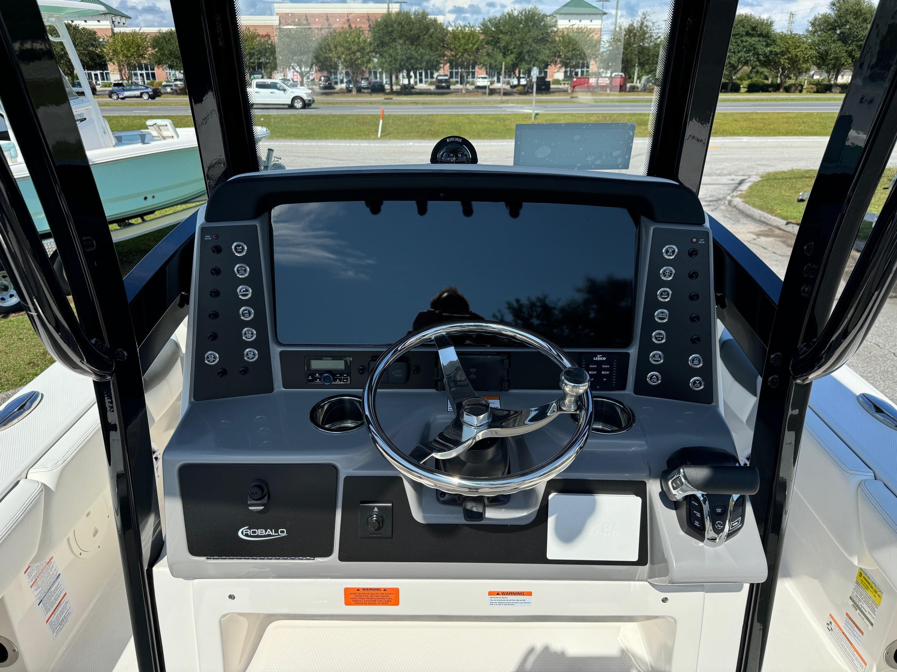 2025 Robalo R246 CAYMAN boat dashboard with steering wheel and control panel.