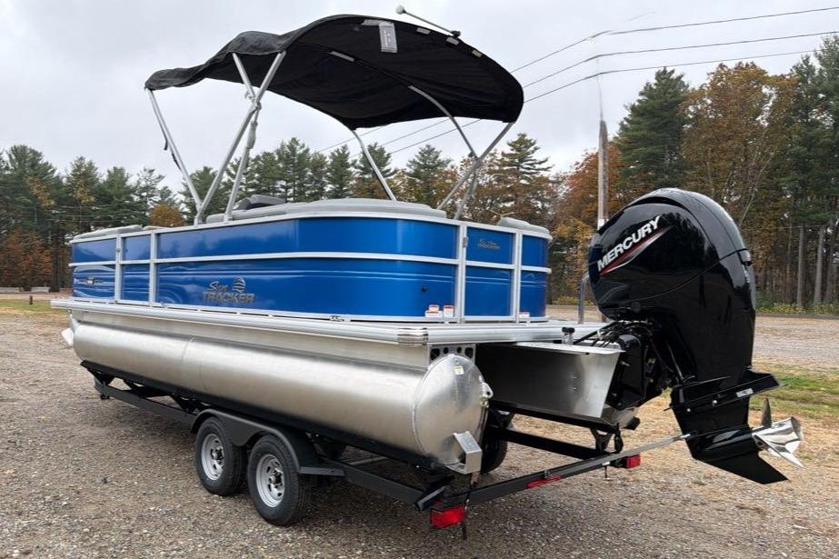 2026 Sun Tracker Party Barge 22 DLX pontoon boat with Mercury outboard motor.
