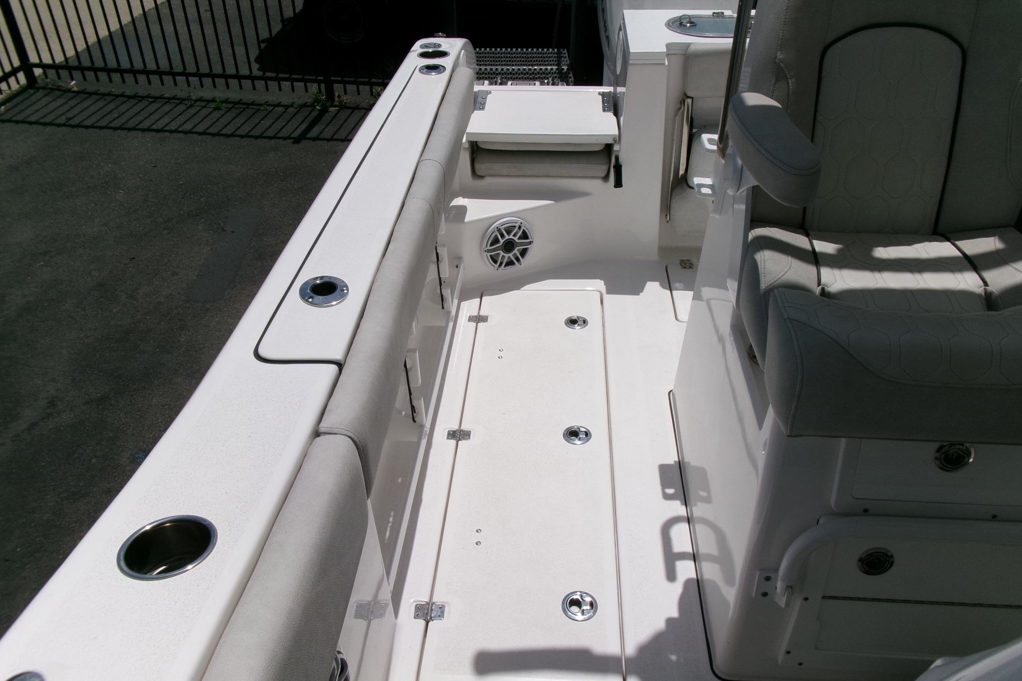 Interior view of 2022 Sea Fox 288 Commander boat, featuring seating and cup holders.