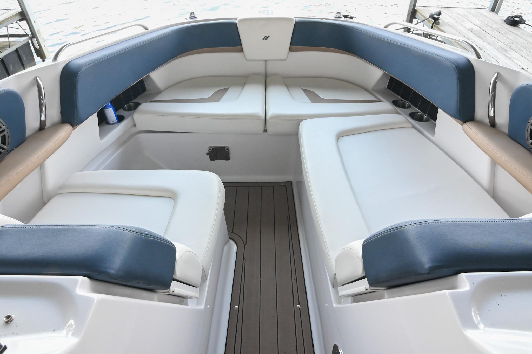Interior seating of 2014 Four Winns H290 boat with blue and white upholstery.