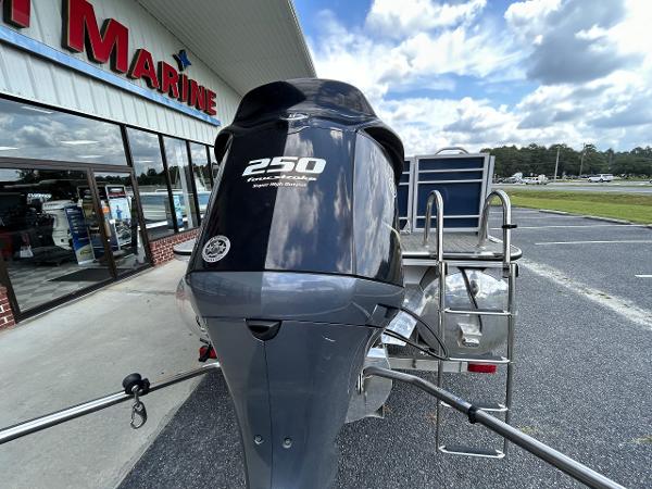 2020 Veranda VP22VLC with 250 HP outboard motor outside a marine store.