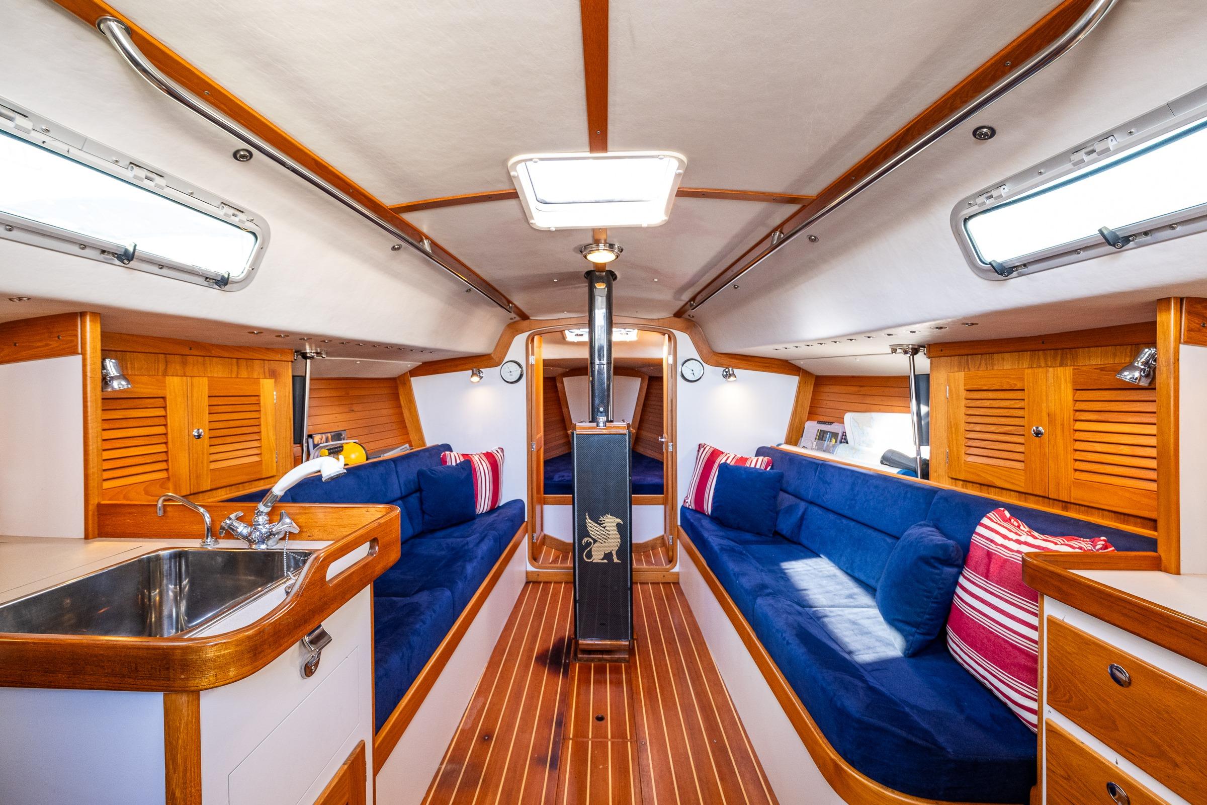 Interior of 2007 J Boats J/124 sailboat with wooden finish and blue seating.