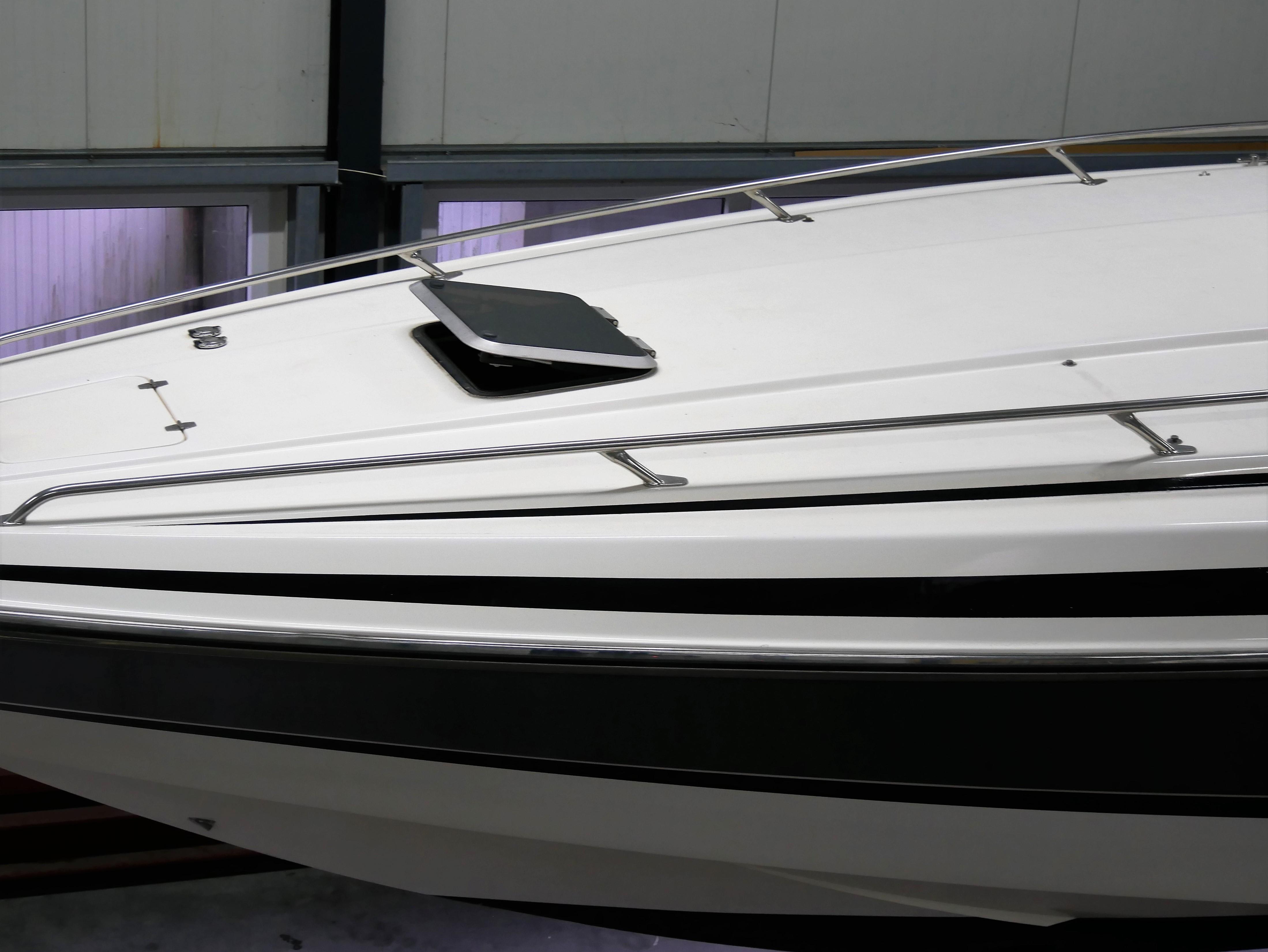 1991 Sunseeker Thunderhawk 43 boat, sleek white exterior with black accents, docked indoors.