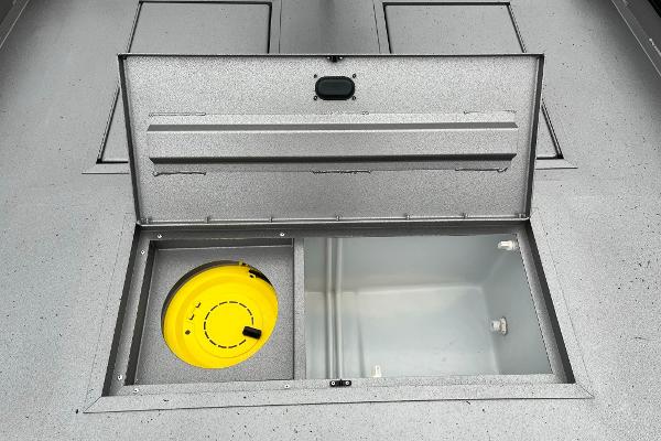 2024 Lowe Legacy boat storage compartment with yellow container.