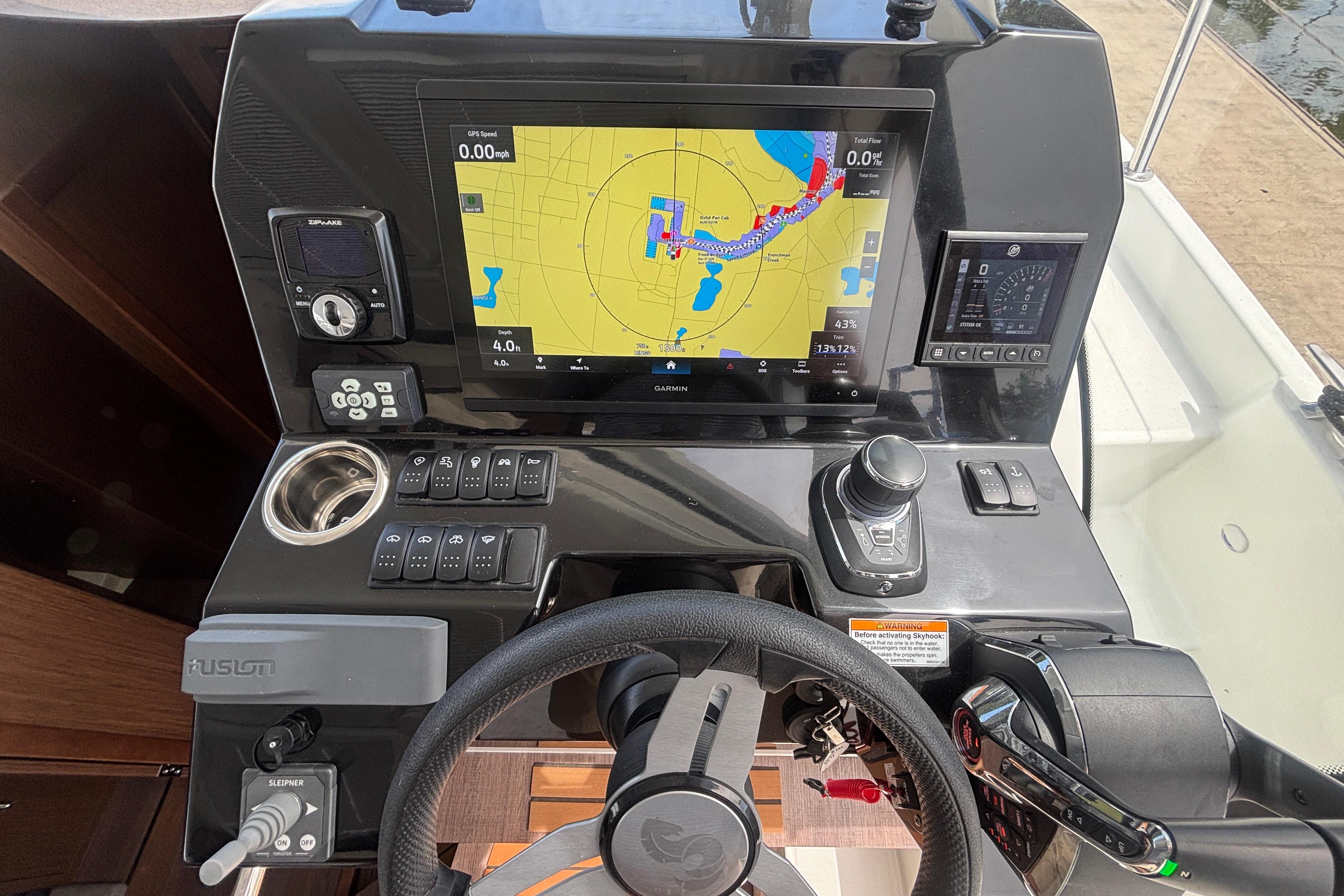2024 Beneteau Antares 11 helm with navigation display and control panel.