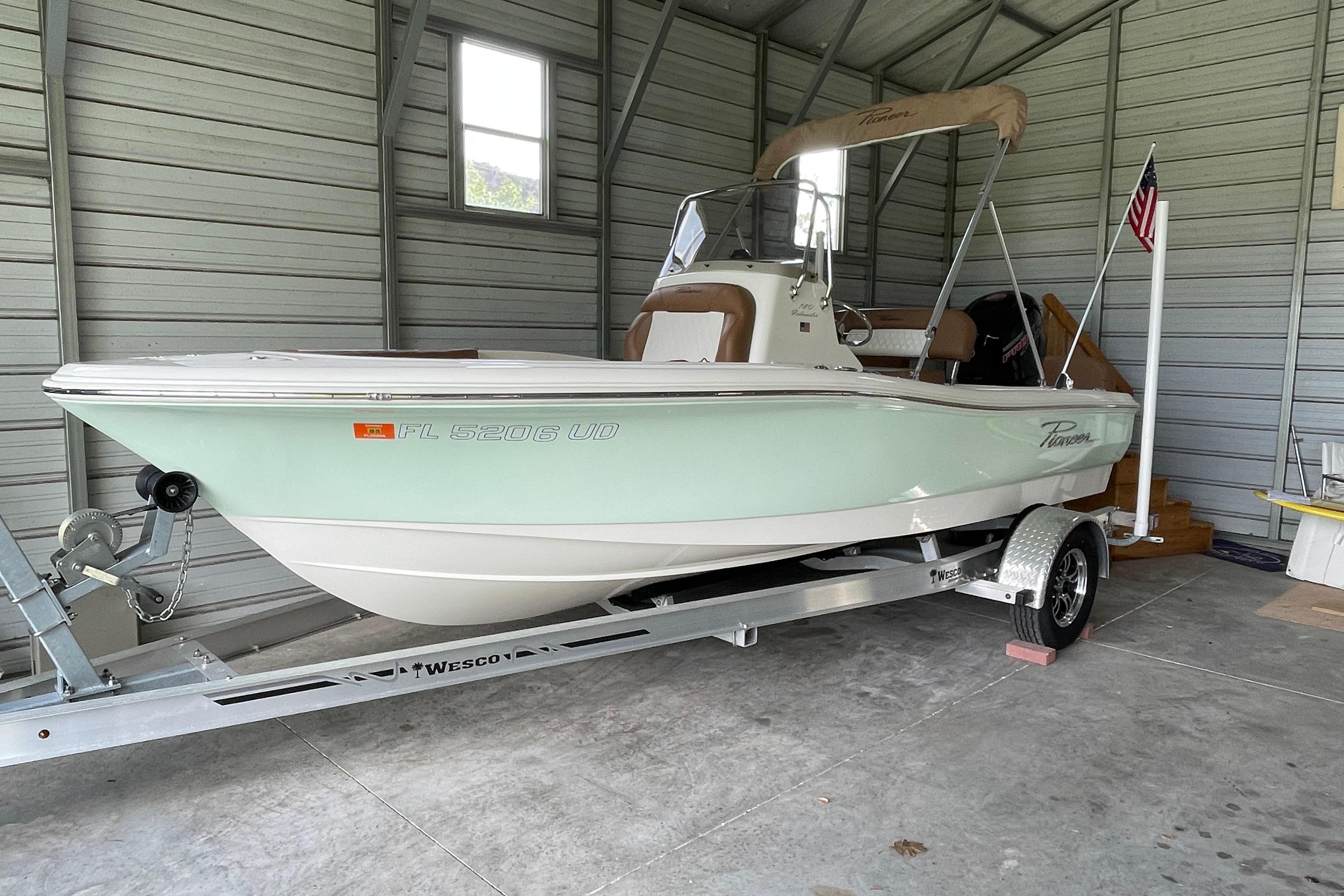 2024 Pioneer 180 Islander boat on trailer in a garage setting.