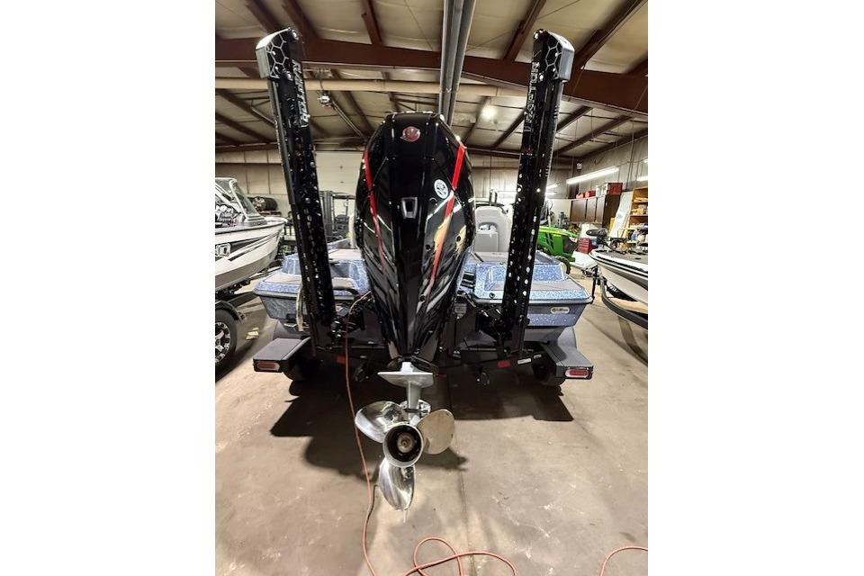 2026 Nitro Z19 XL Pro boat in a warehouse, rear view with motor and propeller.