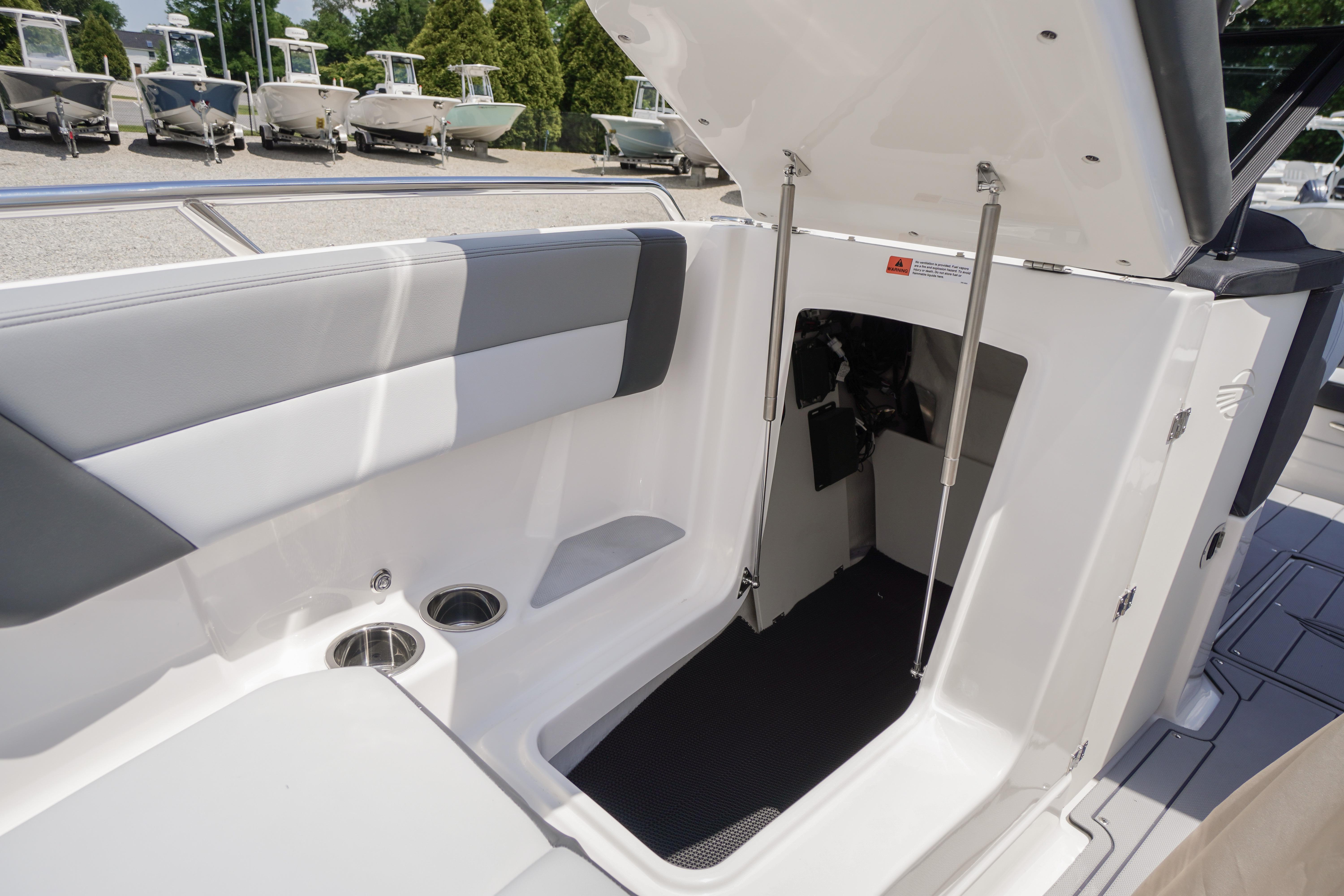 2026 Chaparral SSX 4 boat interior with open storage compartment and seating area.