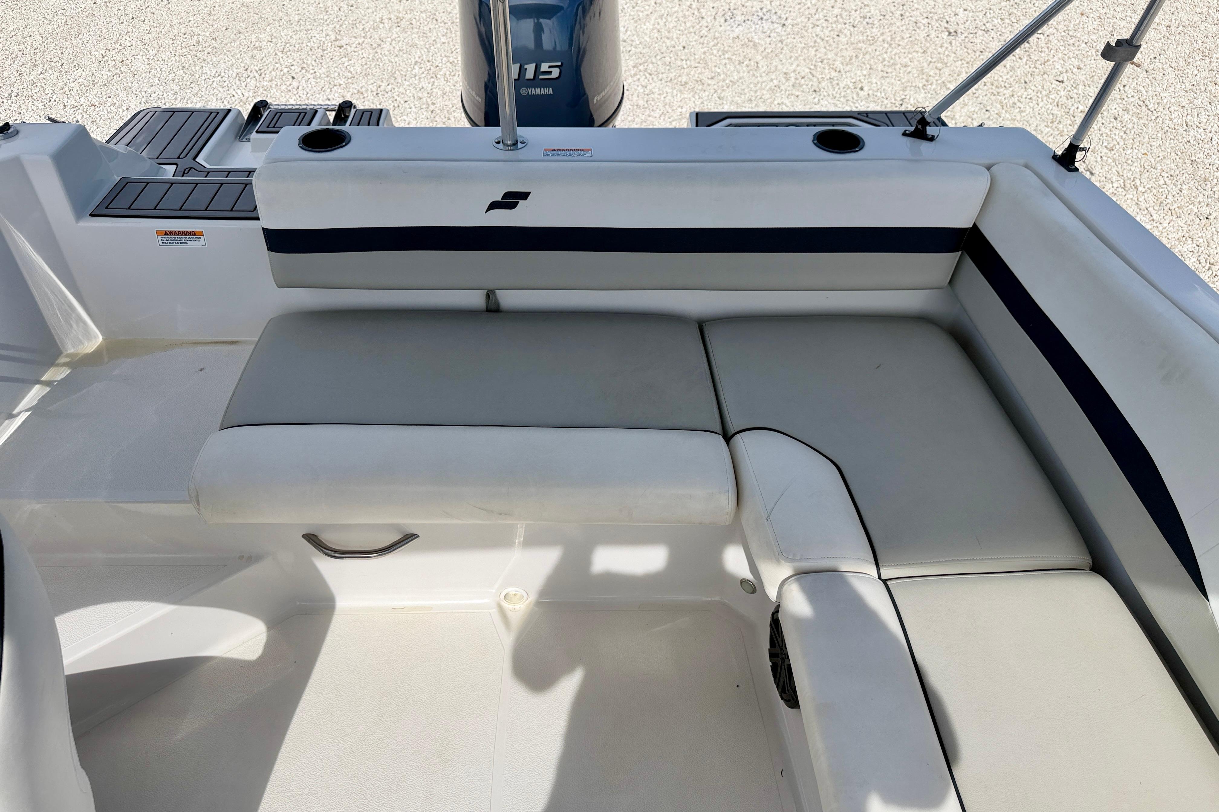 2021 Starcraft SVX 191 OB boat interior with cushioned seating and Yamaha 115 engine.