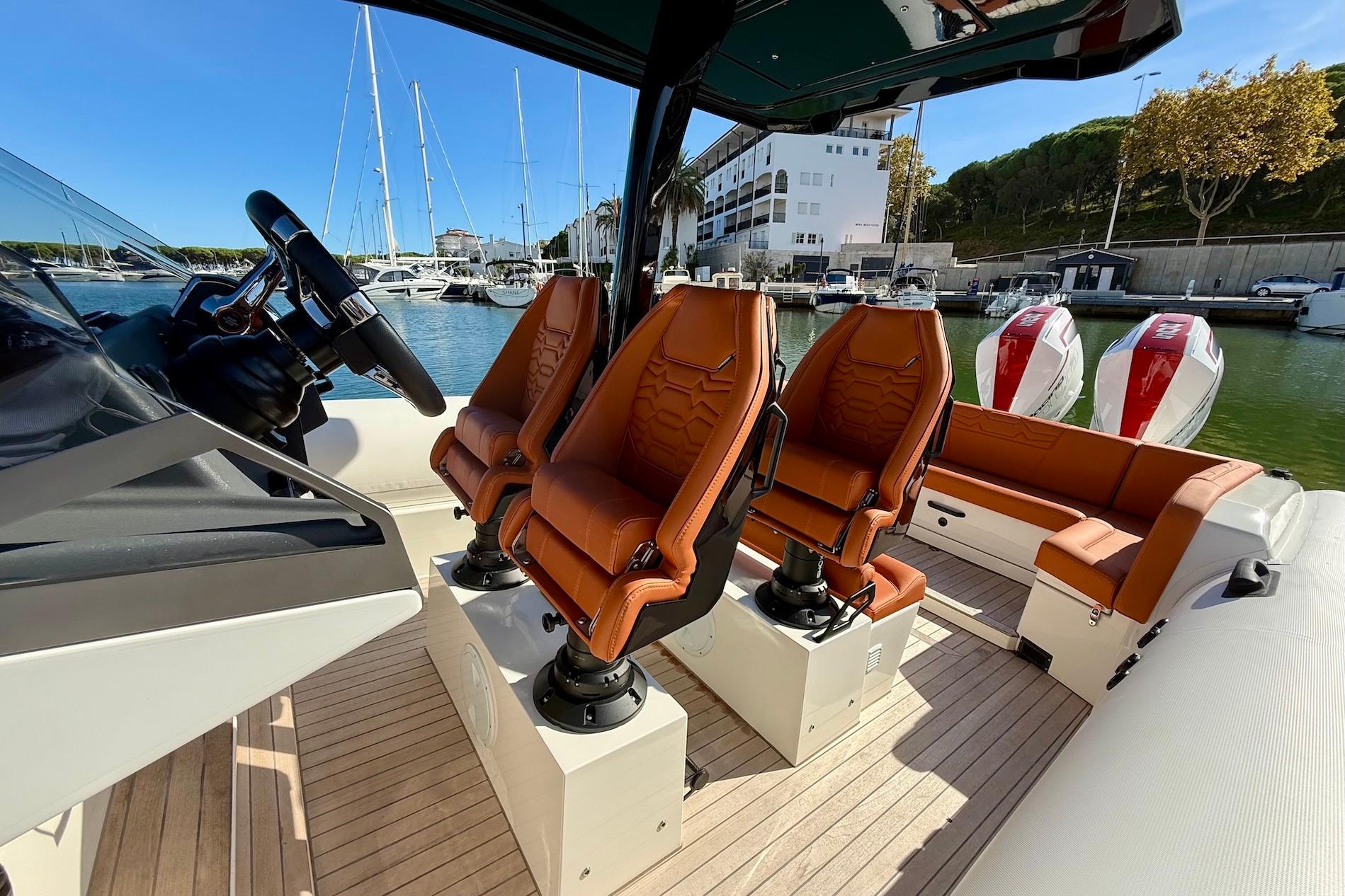 2025 Technohull 38 Grand Sport interior with luxurious seating and modern steering wheel.